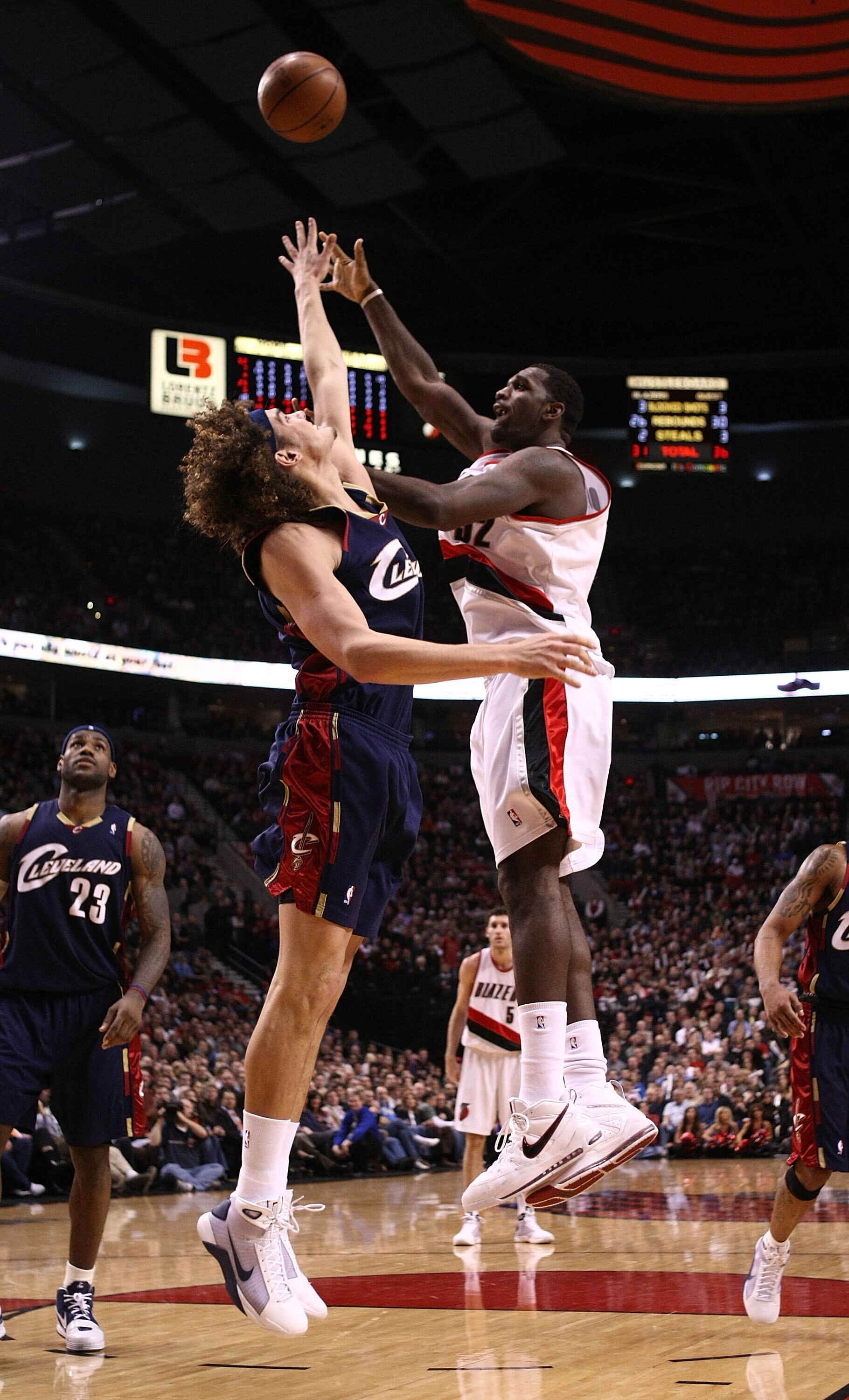 PORTLAND, OR - JANUARY 21:  Greg Oden #52 of the Portland Trail Blazers lays up the ball against Anderson Varejao #17 of the Cleveland Cavaliers at the Rose Garden on January 21, 2009 in Portland, Oregon.  NOTE TO USER: User expressly acknowledges and agr