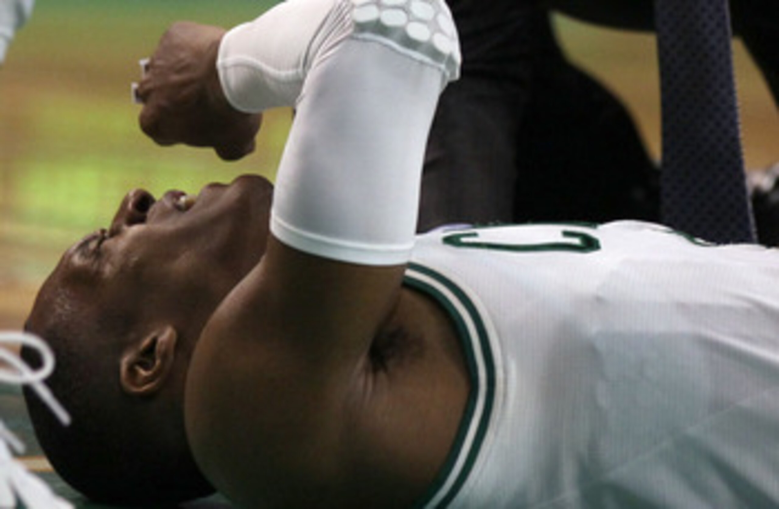BOSTON, MA - MAY 07: Rajon Rondo #9 of the Boston Celtics is tended to after a scramble with Dwyane Wade #3 of the Miami Heat in Game Three of the Eastern Conference Semifinals in the 2011 NBA Playoffs on May 7, 2011 at the TD Garden in Boston, Massachuse