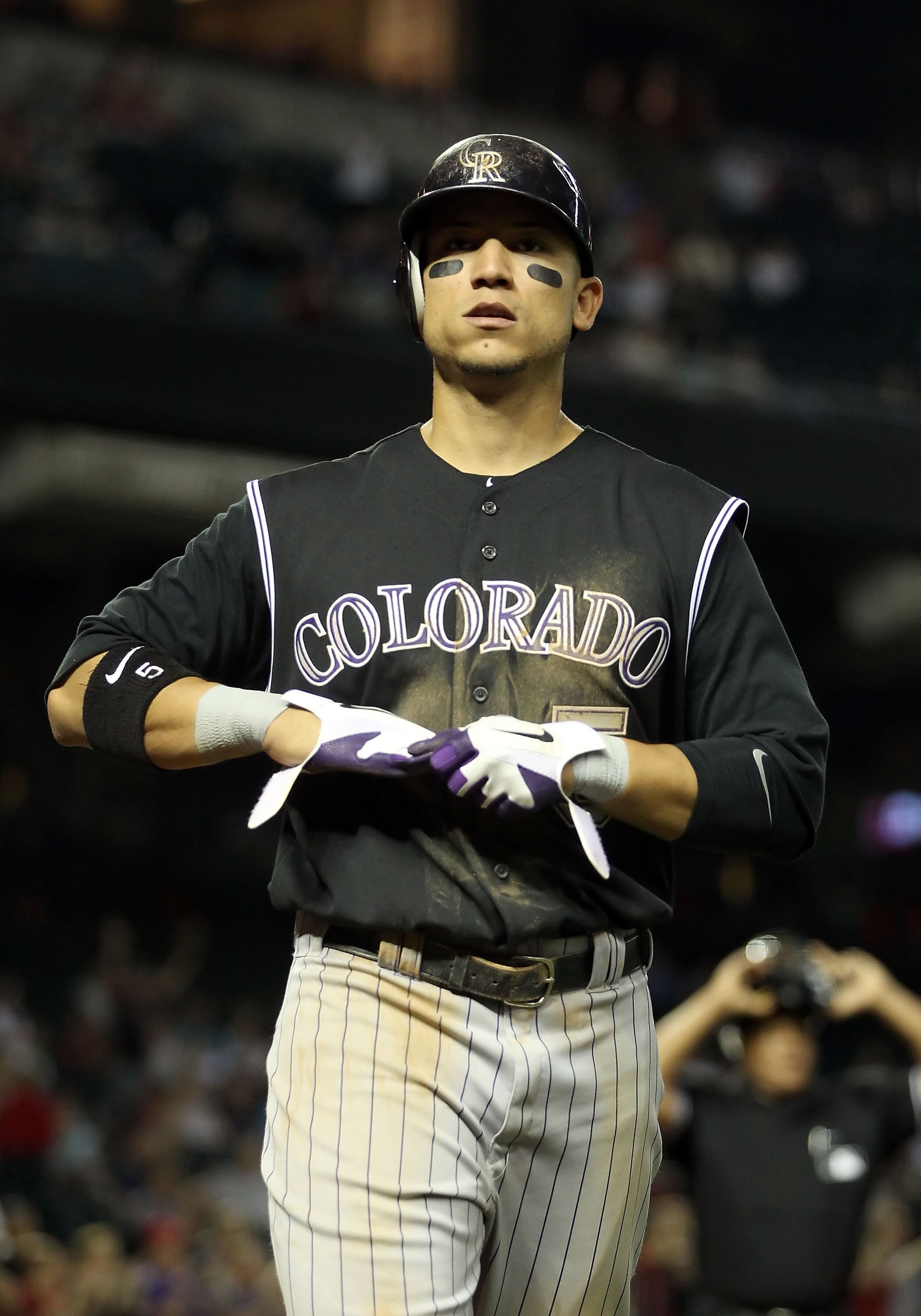 PHOENIX, AZ - MAY 03:  Carlos Gonzalez #5 of the Colorado Rockies walks to the duogut during the Major League Baseball game against the Arizona Diamondbacks at Chase Field on May 3, 2011 in Phoenix, Arizona.  The Diamondbacks defeated the Rockies 4-3.  (P