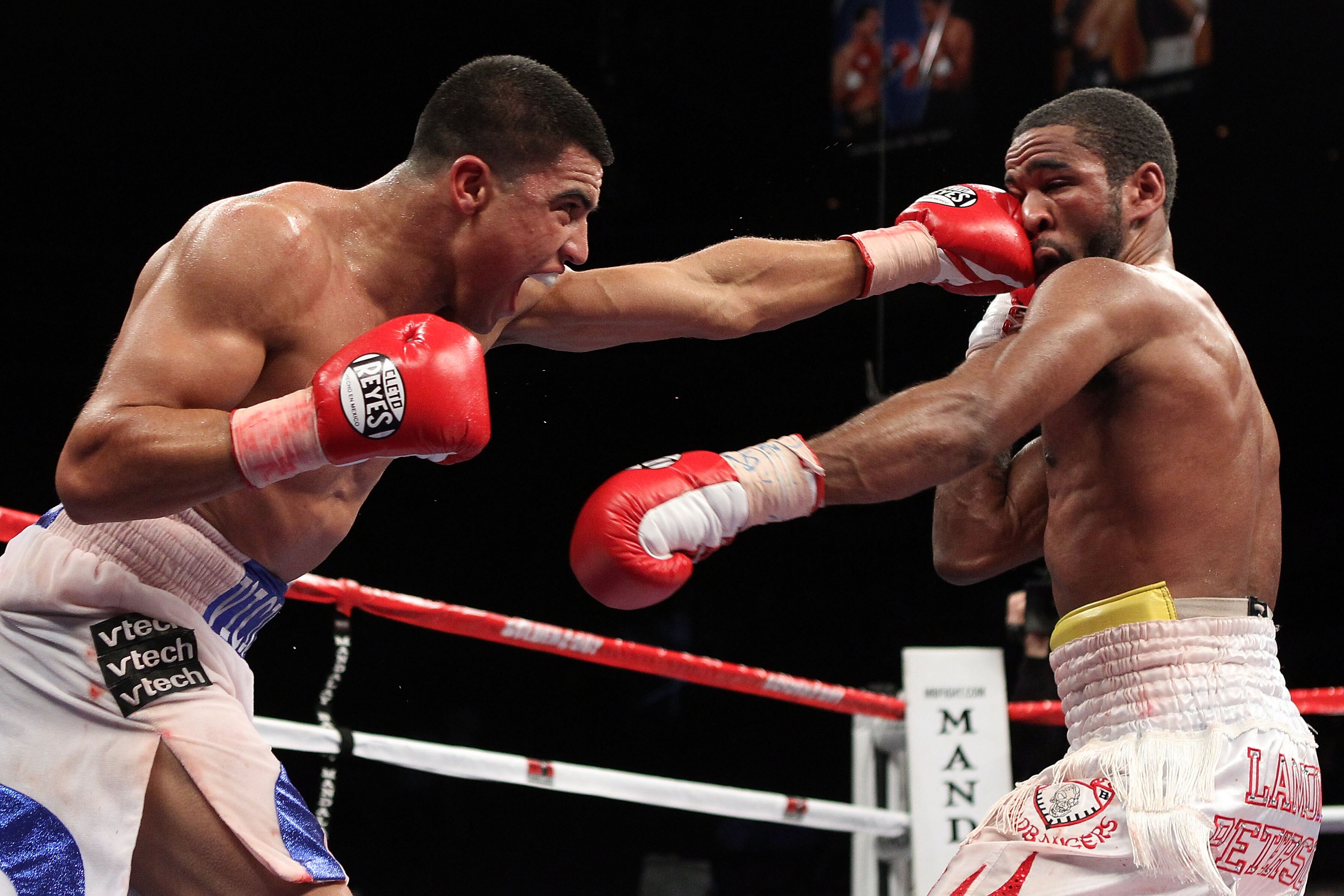 LAS VEGAS - DECEMBER 11:  (L-R) Victor Ortiz connects with a left to the face of Lamont Petersen during the super lightweight fight at Mandalay Bay Events Center on December 11, 2010 in Las Vegas, Nevada.  (Photo by Scott Heavey/Getty Images)