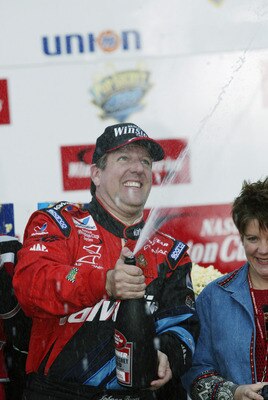 ROCKINGHAM, NC - NOVEMBER 3: Johnny Benson #10, driver of the Valvoline Pontiac, celebrates winning the Pop Secret Microwave Popcorn 400 on November 3, 2002 at North Carolina Speedway in Rockingham, North Carolina. (Photo by Craig Jones/Getty Images) ROCKINGHAM, NC - NOVEMBER 3: Johnny Benson #10, driver of the Valvoline Pontiac, celebrates winning the Pop Secret Microwave Popcorn 400 on November 3, 2002 at North Carolina Speedway in Rockingham, North Carolina. (Photo by Craig Jones/Getty Images)
