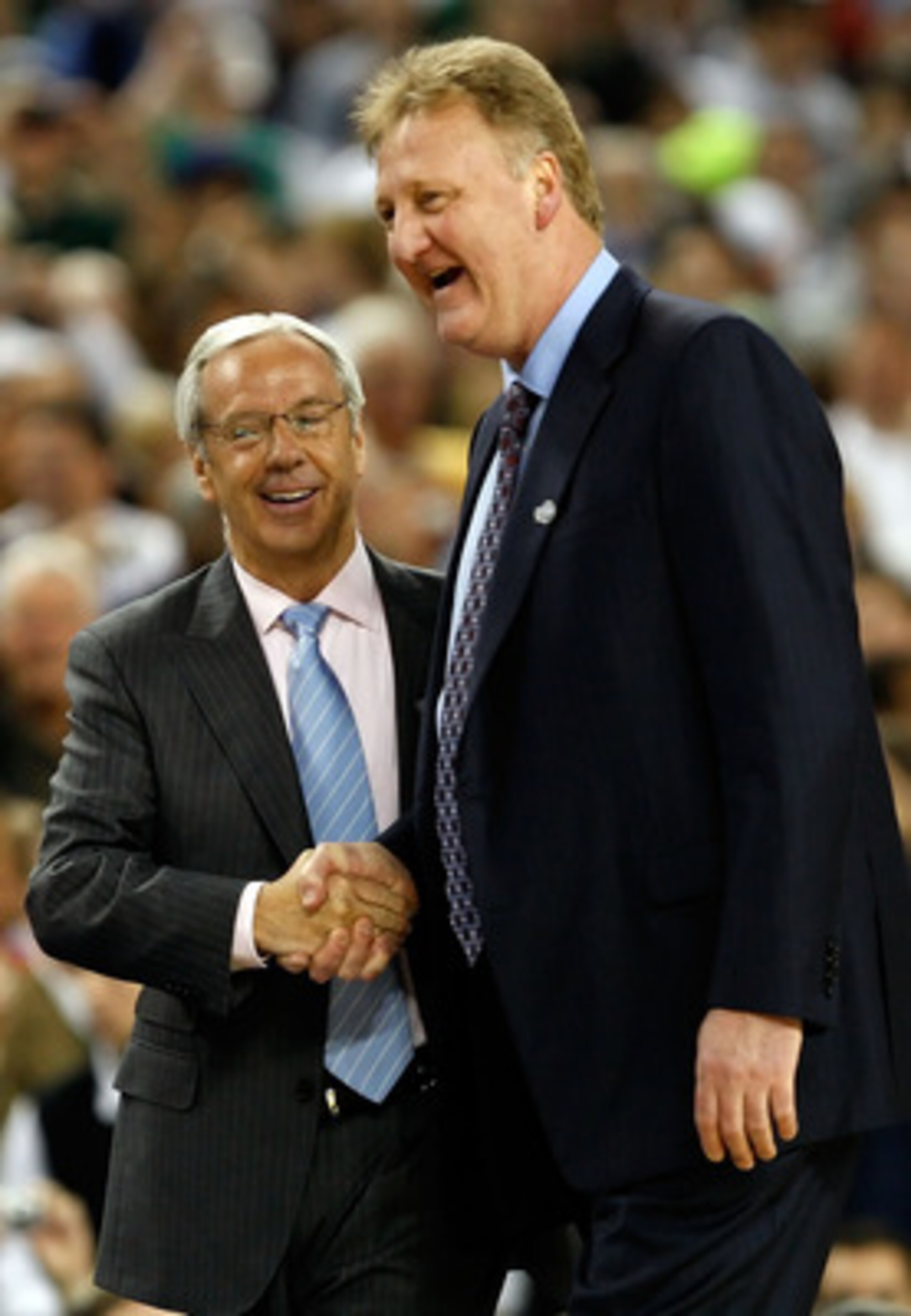 DETROIT - APRIL 06:  Head coach Roy Williams of the North Carolina Tar Heels shakes hands with Larry Bird, who presented the game ball along with Earvin 'Magic' Johnson before the 2009 NCAA Division I Men's Basketball National Championship game at Ford Fi