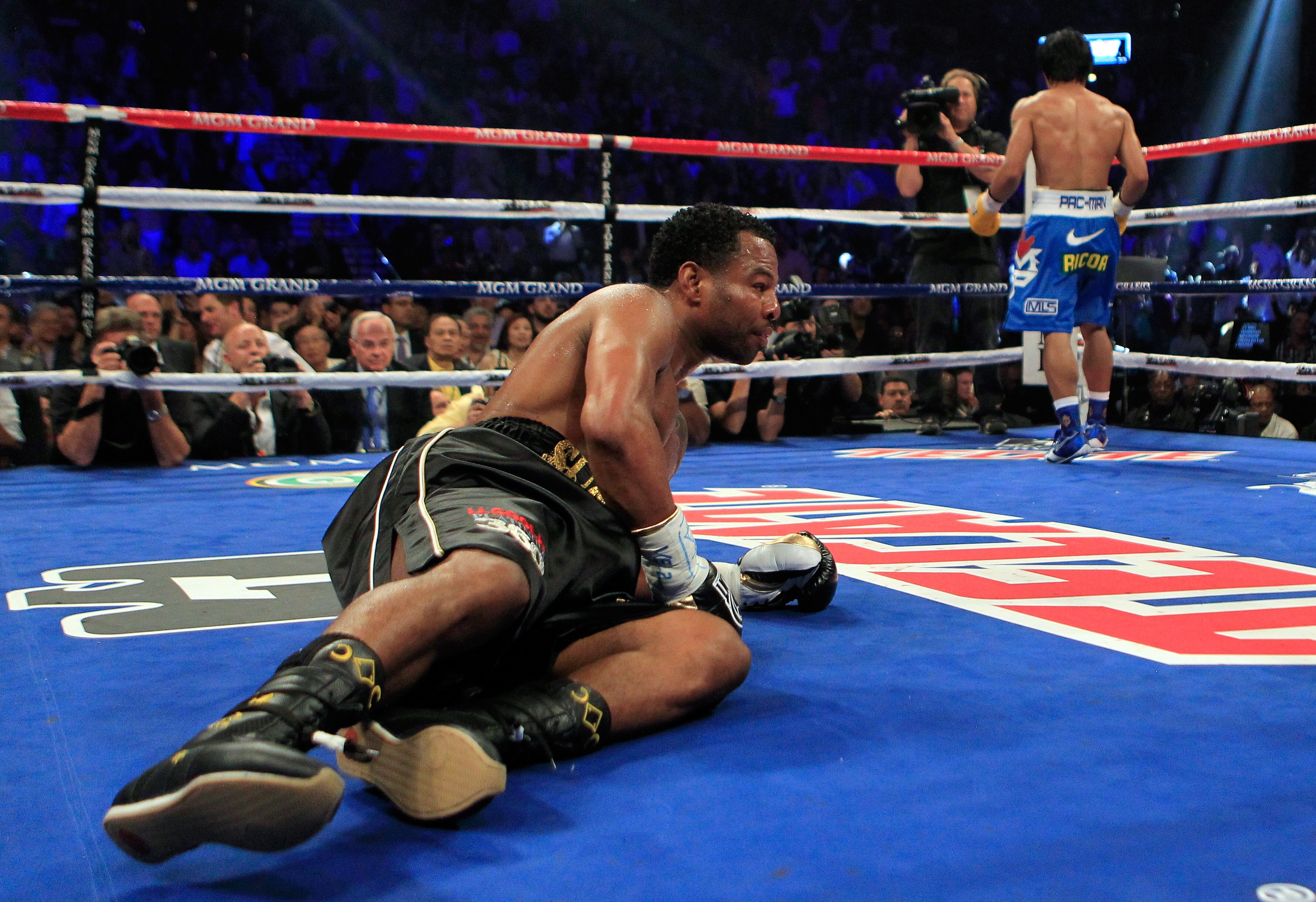 LAS VEGAS, NV - MAY 07:  (L) Shane Mosley is knocked down in the third round by Manny Pacquiao of the Philippines in the WBO welterweight title fight at MGM Grand Garden Arena on May 7, 2011 in Las Vegas, Nevada.  (Photo by Chris Trotman/Getty Images)