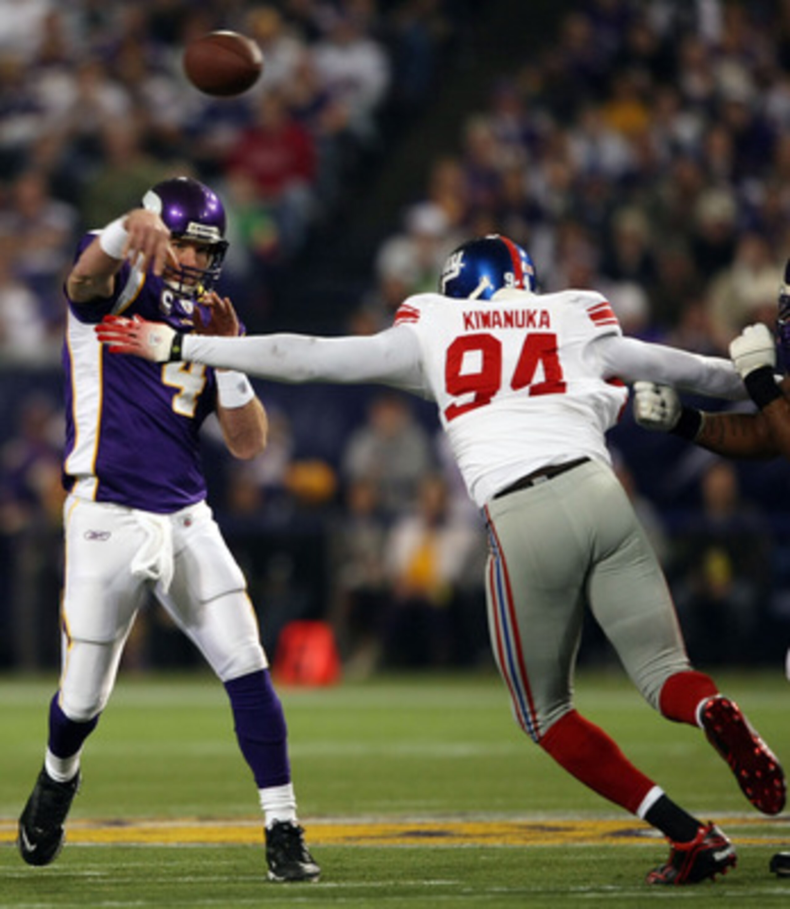 MINNEAPOLIS - JANUARY 03:  Brett Favre #4 of the Minnesota Vikings passes the ball under pressure from Mathias Kiwanuka #94 of the New York Giants on January 3, 2010 at Hubert H. Humphrey Metrodome in Minneapolis, Minnesota. The Vikings defeated the Giant