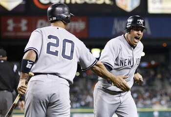 DETROIT, MI - MAY 02:  Mark Teixeira #25 of the New York Yankees celebrates with Jorge Posada #20 after scoring off of a Nick Swisher #33 ninth inning single while playing the Detroit Tigers at Comerica Park on May 2, 2011 in Detroit, Michigan.  (Photo by
