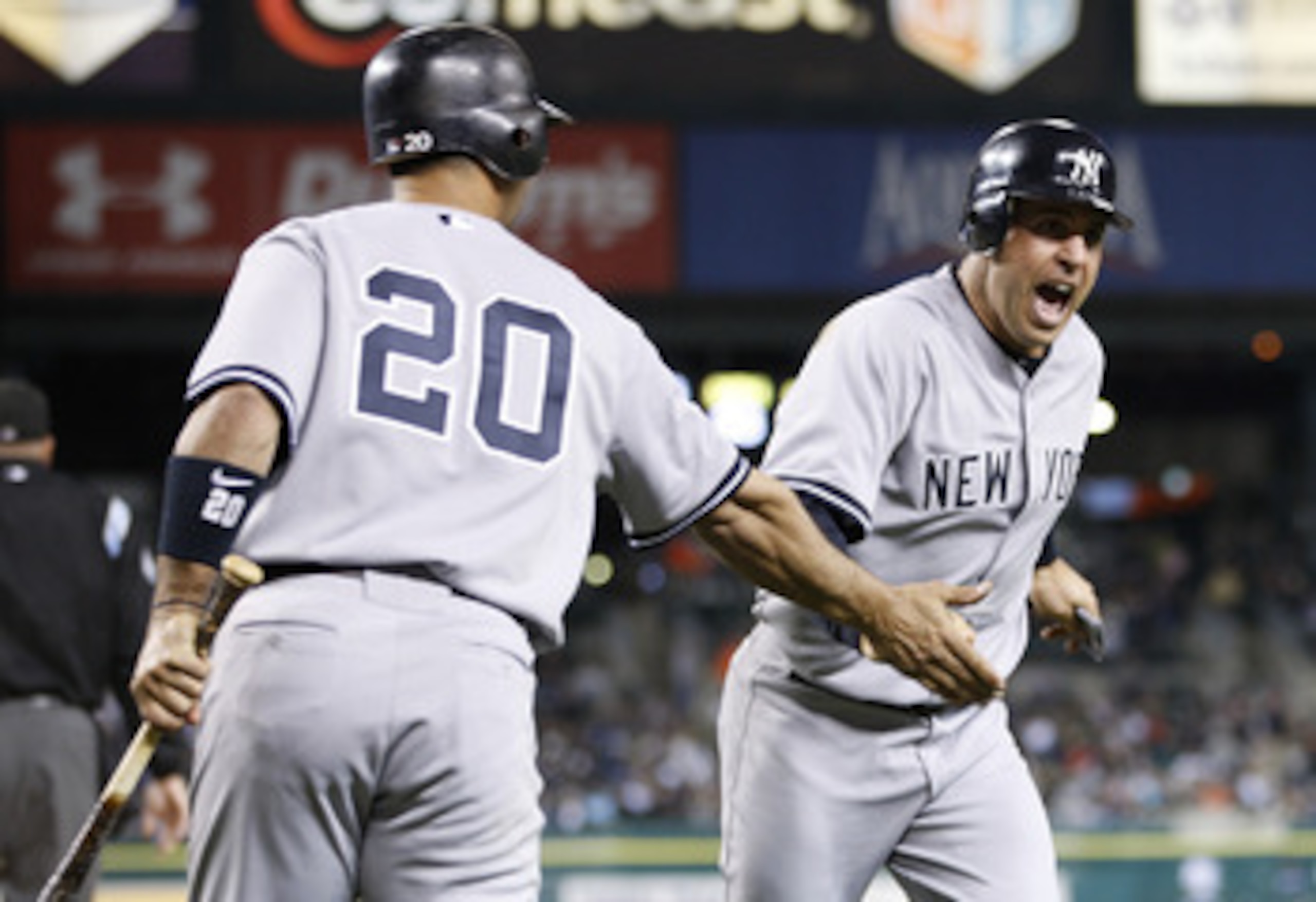 DETROIT, MI - MAY 02:  Mark Teixeira #25 of the New York Yankees celebrates with Jorge Posada #20 after scoring off of a Nick Swisher #33 ninth inning single while playing the Detroit Tigers at Comerica Park on May 2, 2011 in Detroit, Michigan.  (Photo by