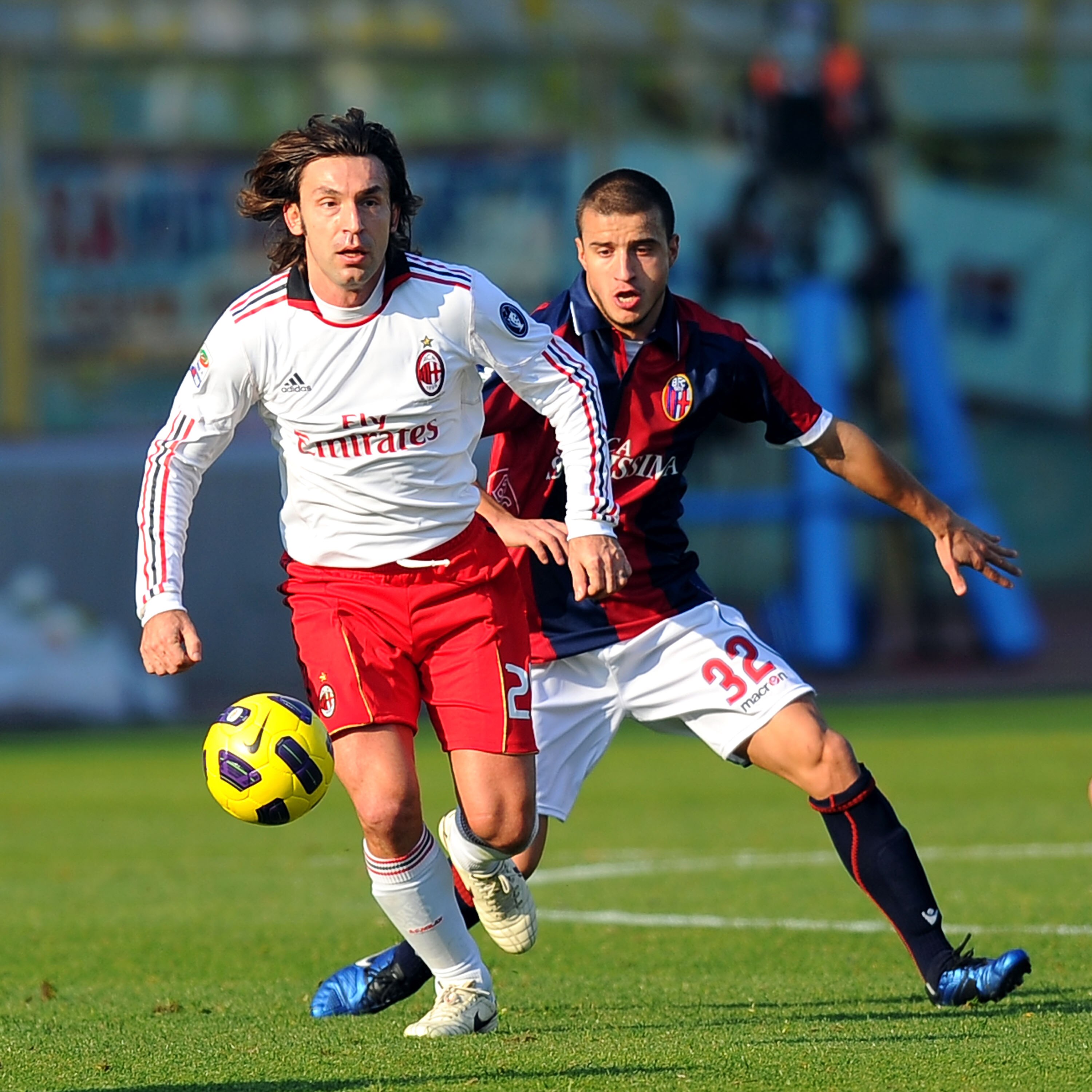 BOLOGNA, ITALY - DECEMBER 12:  Andrea Pirlo of Milan competes with Federico Casarini of Bologna during the Serie A match between Bologna and AC Milan at Stadio Renato Dall'Ara on December 12, 2010 in Bologna, Italy.  (Photo by Roberto Serra/Getty Images)