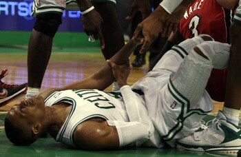 BOSTON, MA - MAY 07: Rajon Rondo #9 of the Boston Celtics injures his arm as he lands on the court after a scramble with Dwyane Wade #3 of the Miami Heat in Game Three of the Eastern Conference Semifinals in the 2011 NBA Playoffs on May 7, 2011 at the TD
