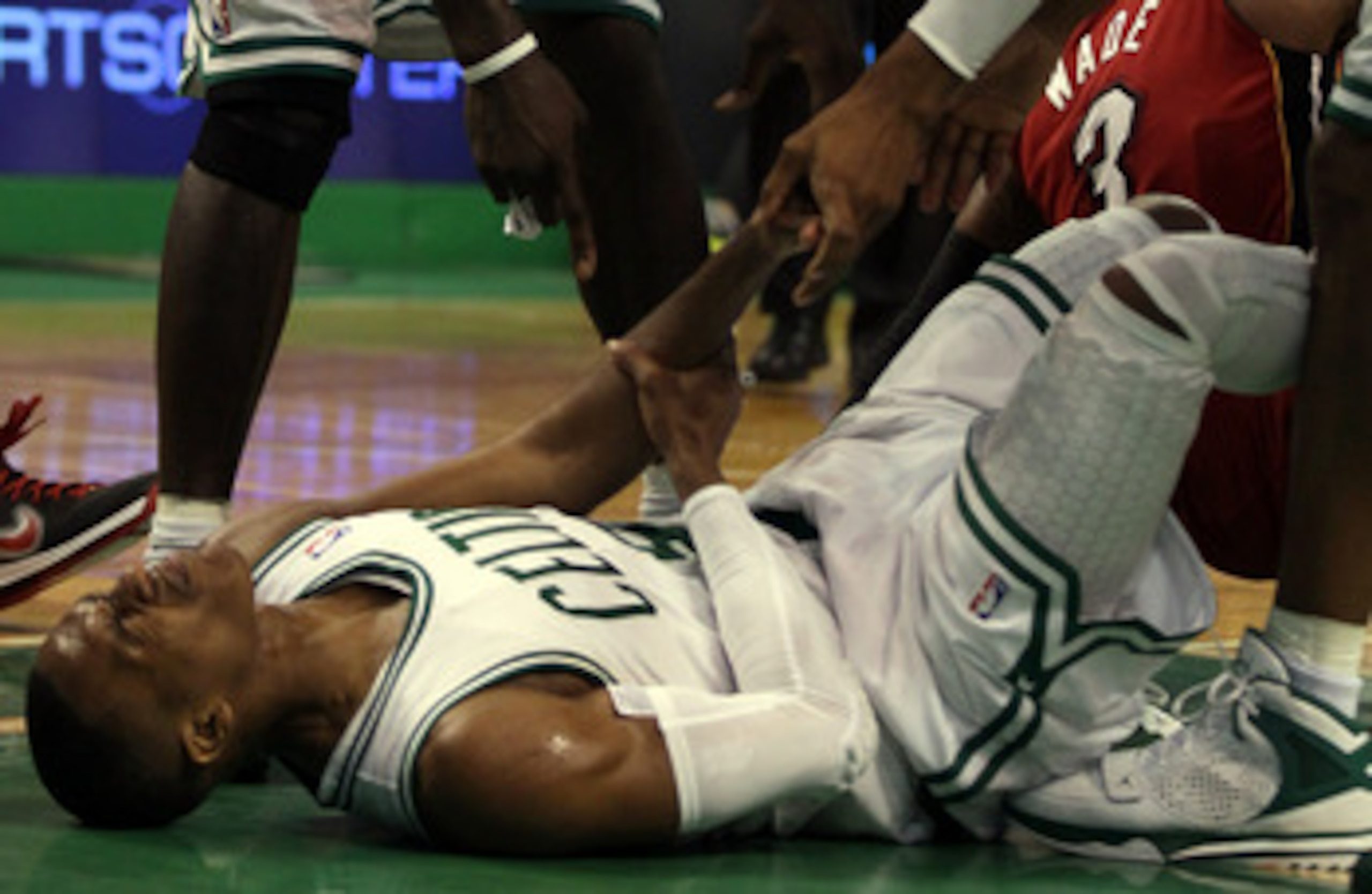 BOSTON, MA - MAY 07: Rajon Rondo #9 of the Boston Celtics injures his arm as he lands on the court after a scramble with Dwyane Wade #3 of the Miami Heat in Game Three of the Eastern Conference Semifinals in the 2011 NBA Playoffs on May 7, 2011 at the TD