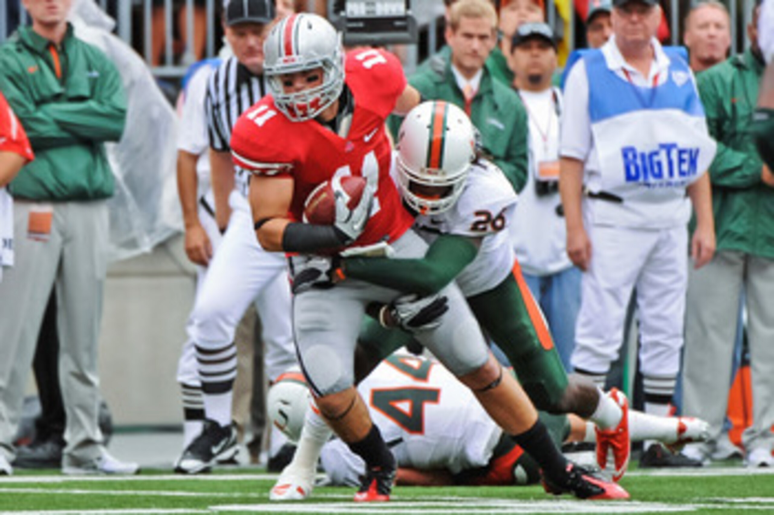 COLUMBUS, OH - SEPTEMBER 11:  Jake Stoneburner #11 of the Ohio State Buckeyes attempts to gain extra yardage after catching a pass against the Miami Hurricanes at Ohio Stadium on September 11, 2010 in Columbus, Ohio.  (Photo by Jamie Sabau/Getty Images)