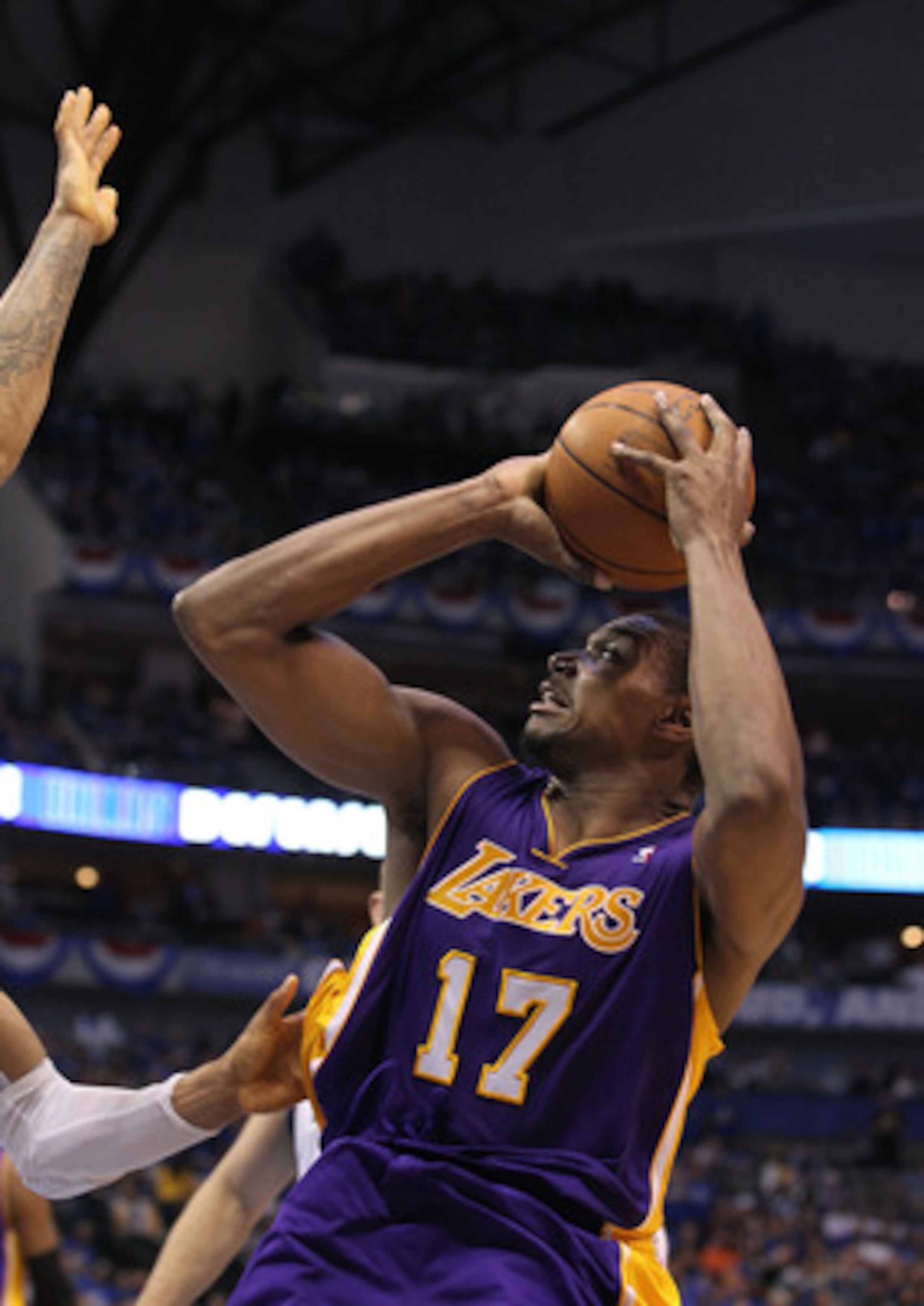 DALLAS, TX - MAY 06: Center Andrew Bynum #17 of the Los Angeles Lakers takes a shot against the Dallas Mavericks in Game Three of the Western Conference Semifinals during the 2011 NBA Playoffs on May 6, 2011 at American Airlines Center in Dallas, Texas. DALLAS, TX - MAY 06: Center Andrew Bynum #17 of the Los Angeles Lakers takes a shot against the Dallas Mavericks in Game Three of the Western Conference Semifinals during the 2011 NBA Playoffs on May 6, 2011 at American Airlines Center in Dallas, Texas.