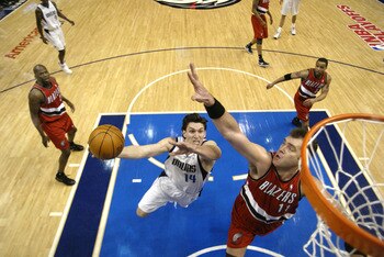 DALLAS - MAY 4:  Eduardo Najera #14 of the Dallas Mavericks shoots past Arvydas Sabonis #11 of the Portland Trail Blazers in Game seven of the Western Conference Quarterfinals during the 2003 NBA Playoffs at American Airlines Center on May 4, 2003 in Dall