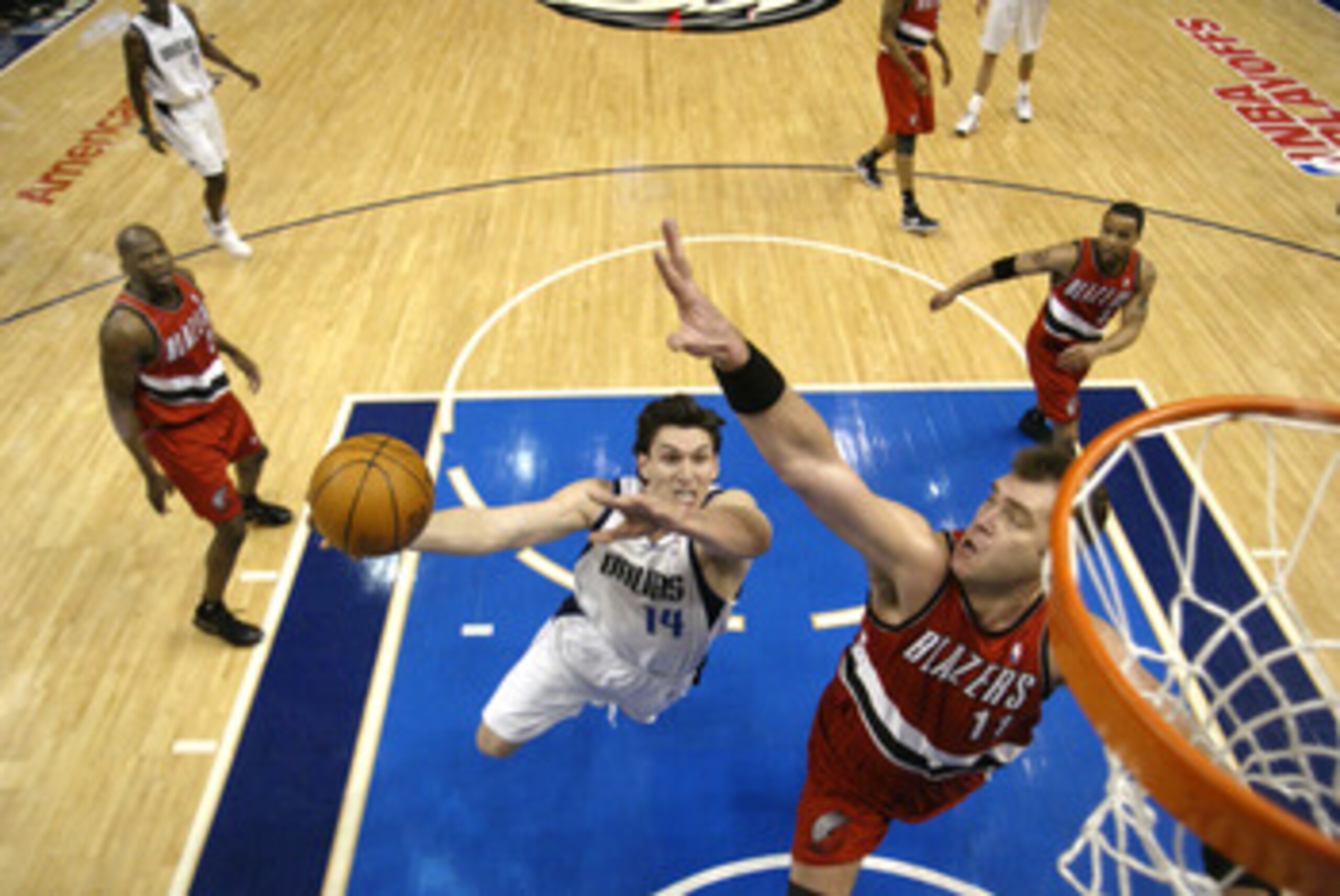 DALLAS - MAY 4:  Eduardo Najera #14 of the Dallas Mavericks shoots past Arvydas Sabonis #11 of the Portland Trail Blazers in Game seven of the Western Conference Quarterfinals during the 2003 NBA Playoffs at American Airlines Center on May 4, 2003 in Dall