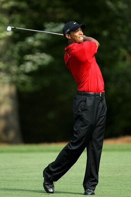 AUGUSTA, GA - APRIL 10:  Tiger Woods hits his second shot on the 11th hole during the final round of the 2011 Masters Tournament at Augusta National Golf Club on April 10, 2011 in Augusta, Georgia.  (Photo by Jamie Squire/Getty Images)
