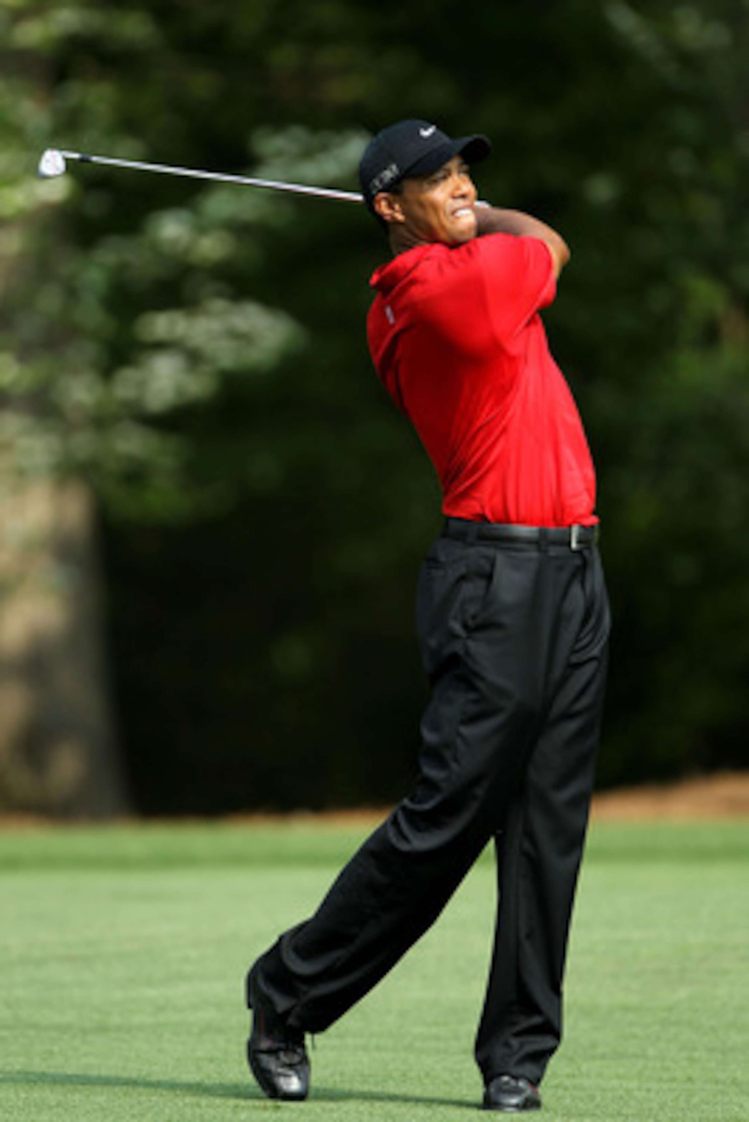 AUGUSTA, GA - APRIL 10:  Tiger Woods hits his second shot on the 11th hole during the final round of the 2011 Masters Tournament at Augusta National Golf Club on April 10, 2011 in Augusta, Georgia.  (Photo by Jamie Squire/Getty Images)