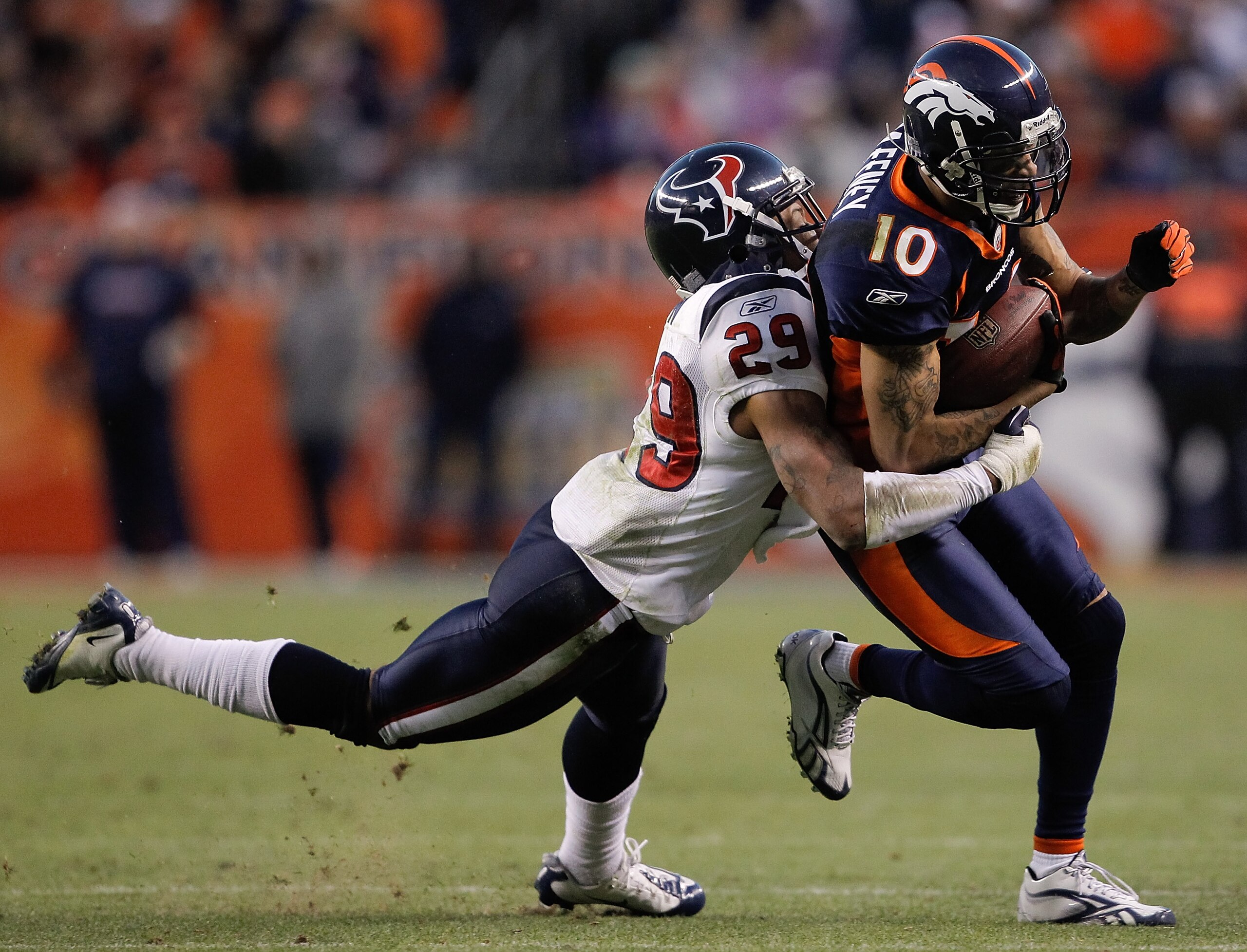 DENVER - DECEMBER 26:  Wide receiver Jabar Gaffney #10 of the Denver Broncos is tackled by corner back Glover Quin #29 of the Houston Texans during the fourth quarter at INVESCO Field at Mile High on December 26, 2010 in Denver, Colorado.  The Denver Bron