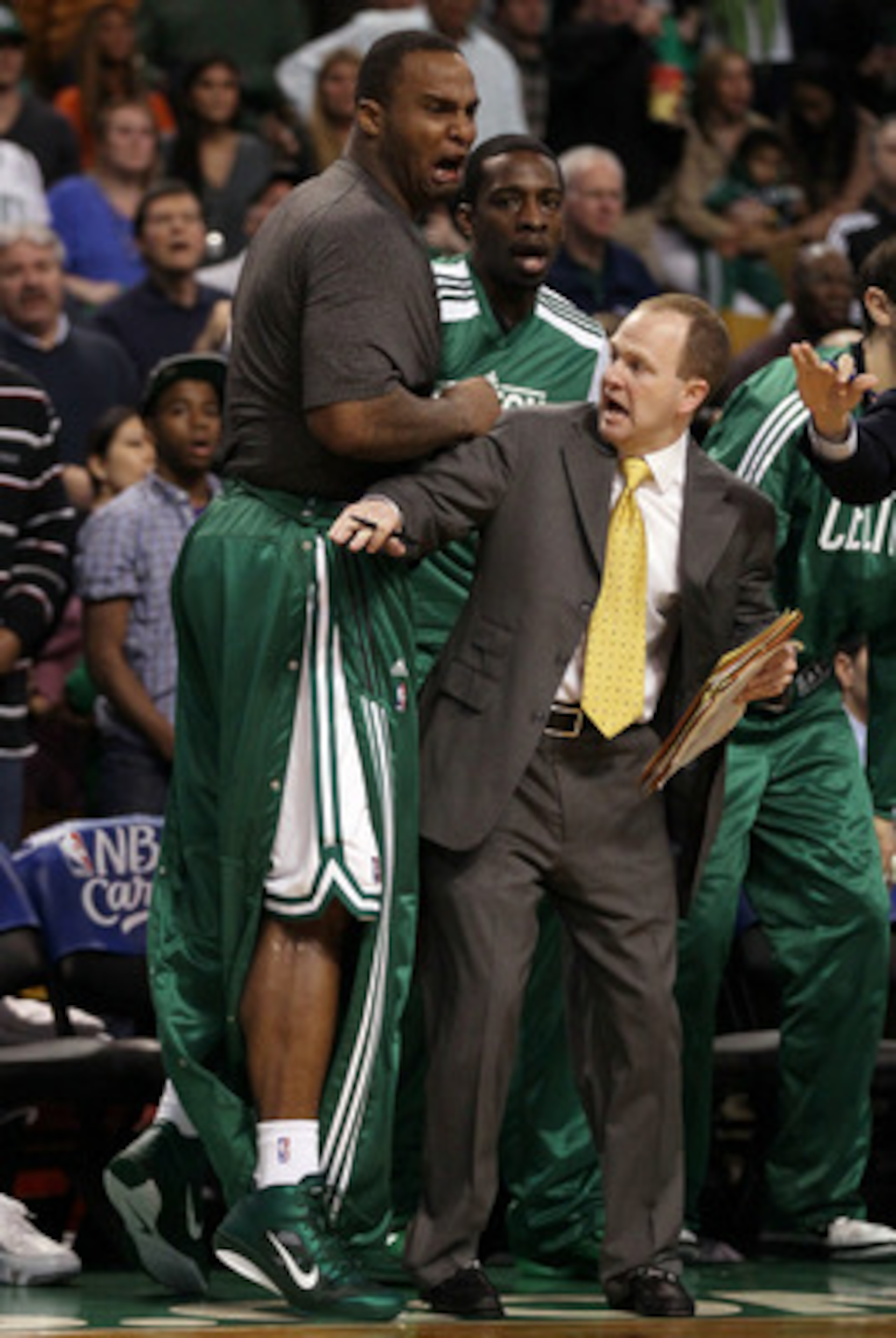 BOSTON, MA - MAY 07:  Assistant coach Lawrence Frank of the Boston Celtics holds back Glen Davis #11 after teammate Rajon Rondo #9 was injured after a scuffle with Dwyane Wade #3 of the Miami Heat in Game Three of the Eastern Conference Semifinals in the 