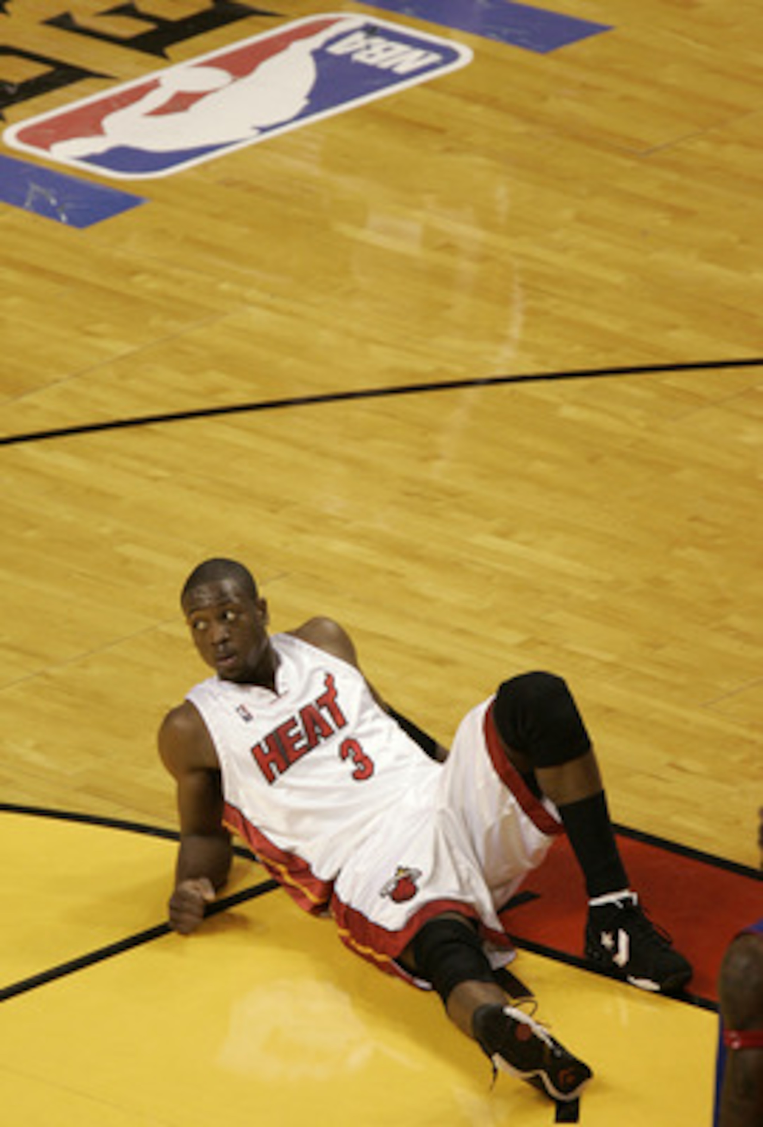 MIAMI - JUNE 6:  Dwyane Wade #3 of the Miami Heat looks up from the court floor against the Detroit Pistons in Game Seven of the Eastern Conference Finals during the 2005 NBA Playoffs June 6, 2005 at the American Airlines Arena in Miami, Florida. The Pist