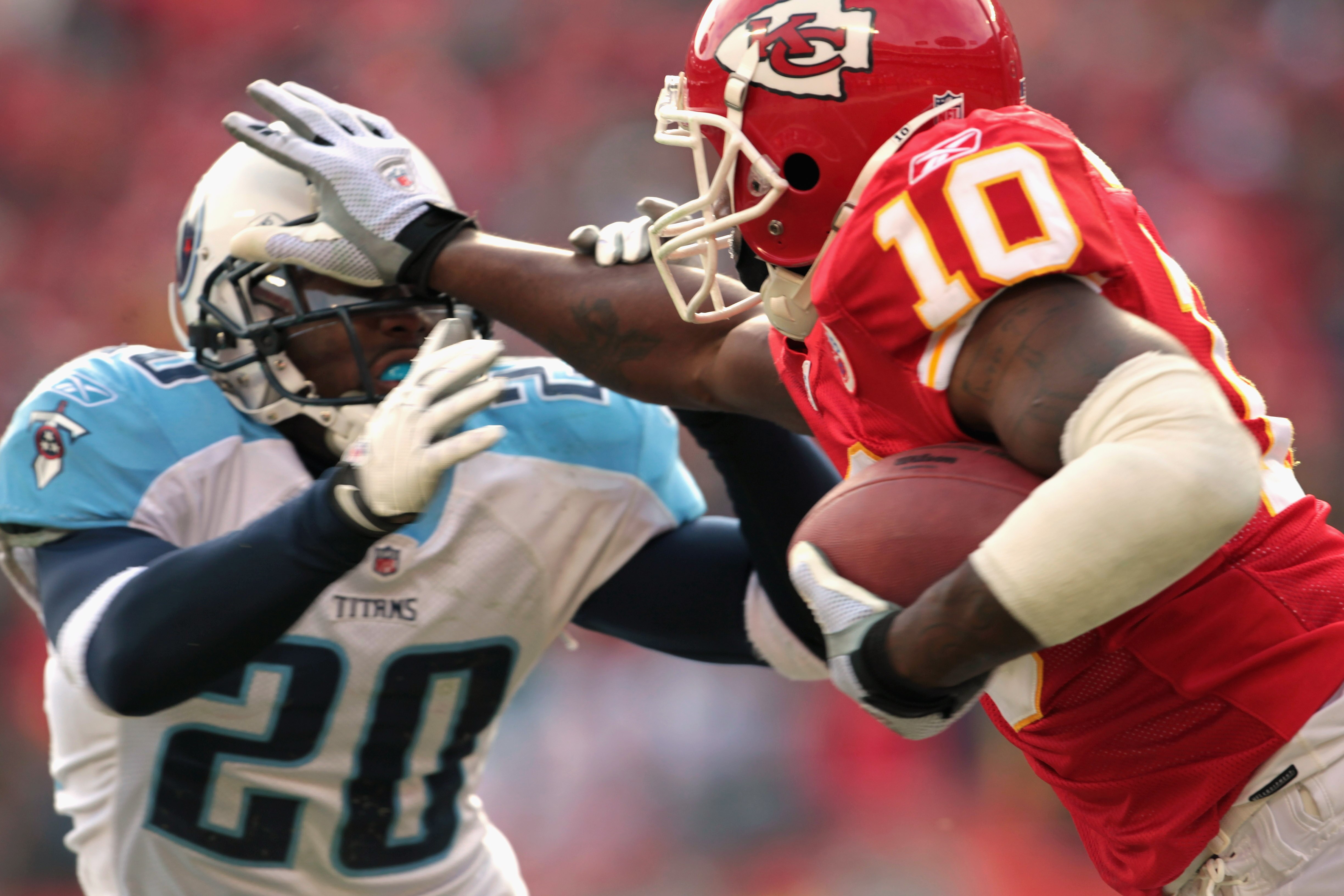 KANSAS CITY, MO - DECEMBER 26:  Terrance Copper #10 of the Kansas City Chiefs carries the ball while stiff-arming Alterraun Verner #20 of the Tennessee Titans during the game on December 26, 2010 at Arrowhead Stadium in Kansas City, Missouri.  (Photo by J