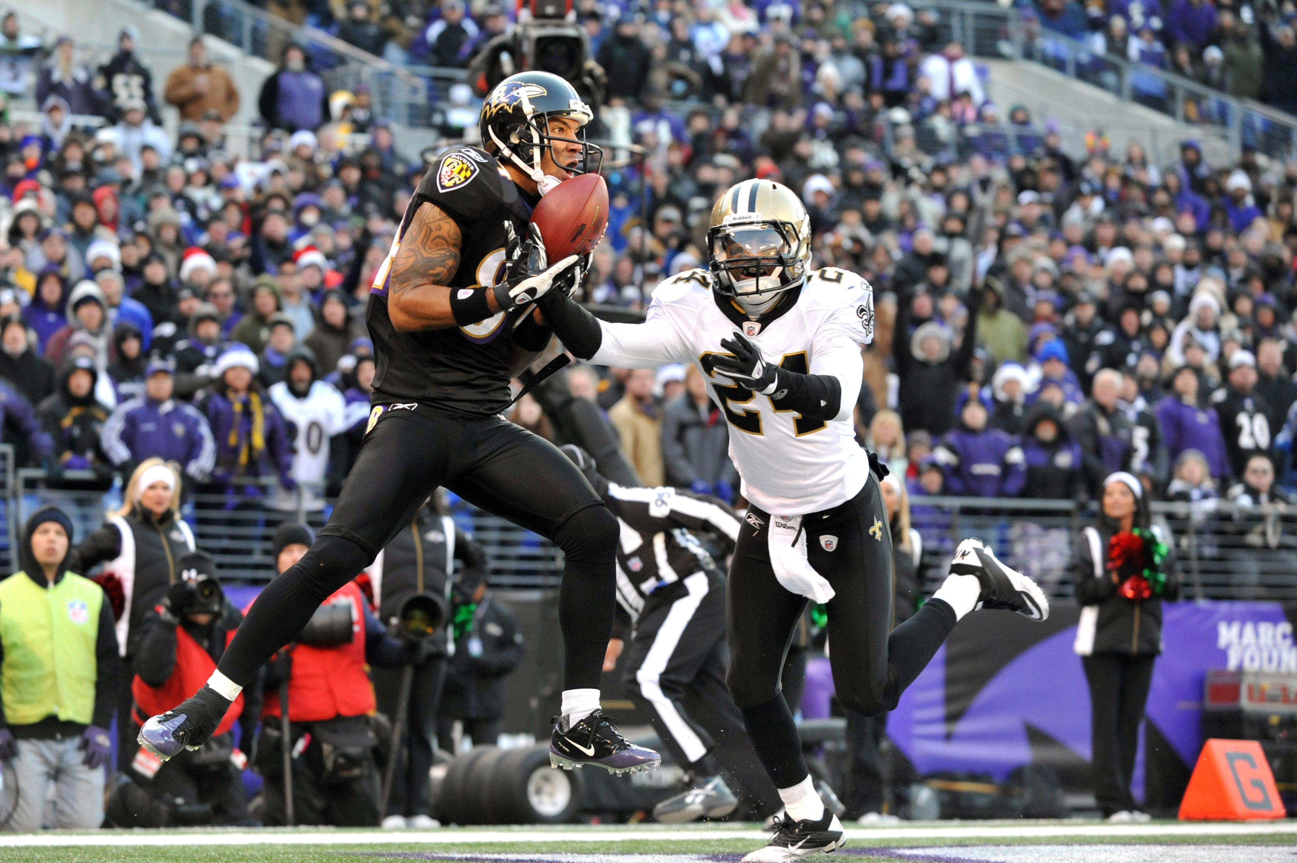 BALTIMORE, MD - DECEMBER 19:  T.J. Houshmandzadeh #84 of the Baltimore Ravens makes a catch that did not count for a touchdown when he was pushed out of bounds by Leigh Torrence #24 of the New Orleans Saints  at M&T Bank Stadium on December 19, 2010 in Ba