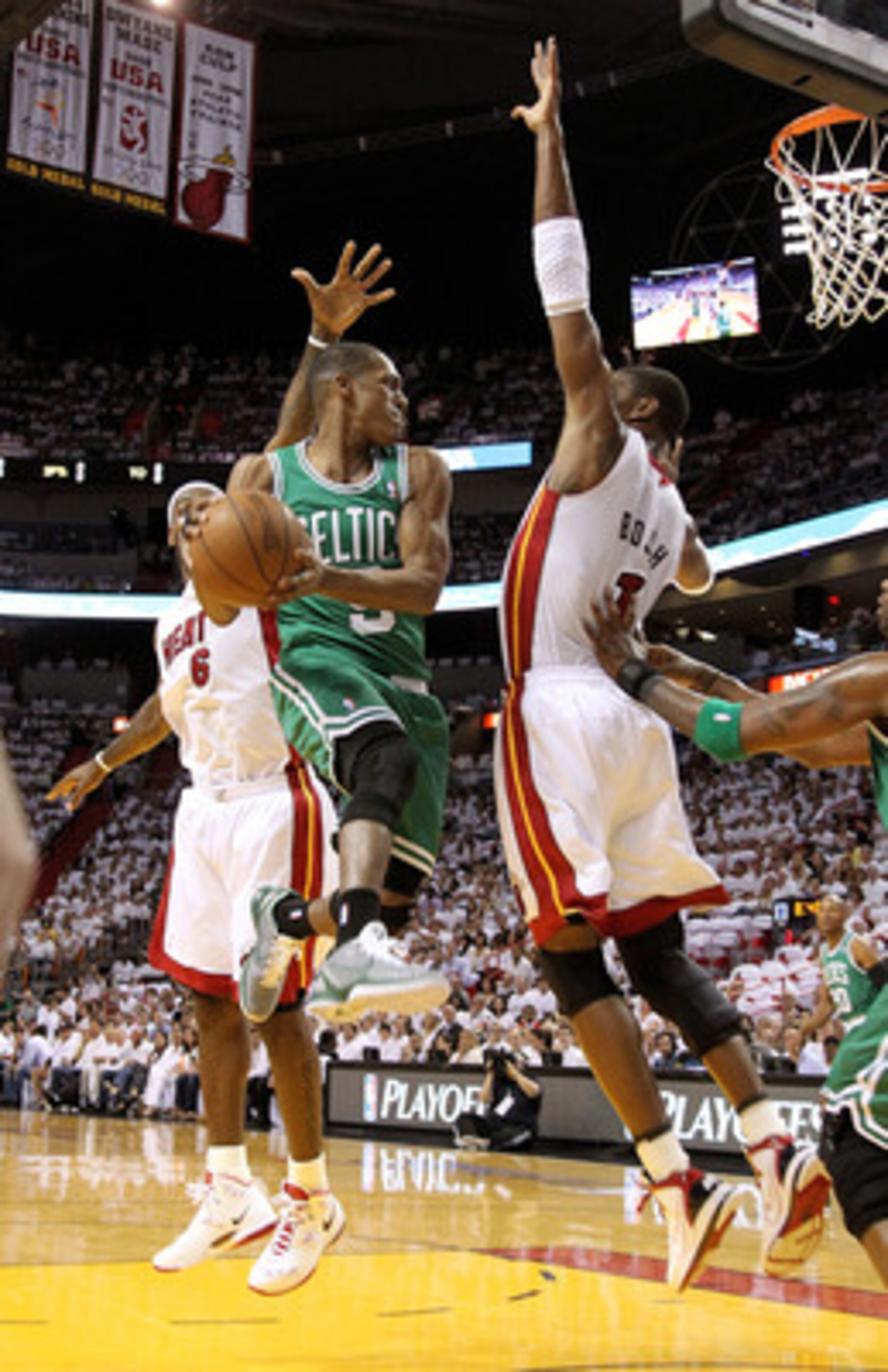 MIAMI, FL - MAY 03:  Rajon Rondo #9 of the Boston Celtics takes a shot against Chris Bosh #1 and LeBron James #6 of  the Miami Heat during Game Two of the Eastern Conference Semifinals of the 2011 NBA Playoffs at American Airlines Arena on May 3, 2011 in