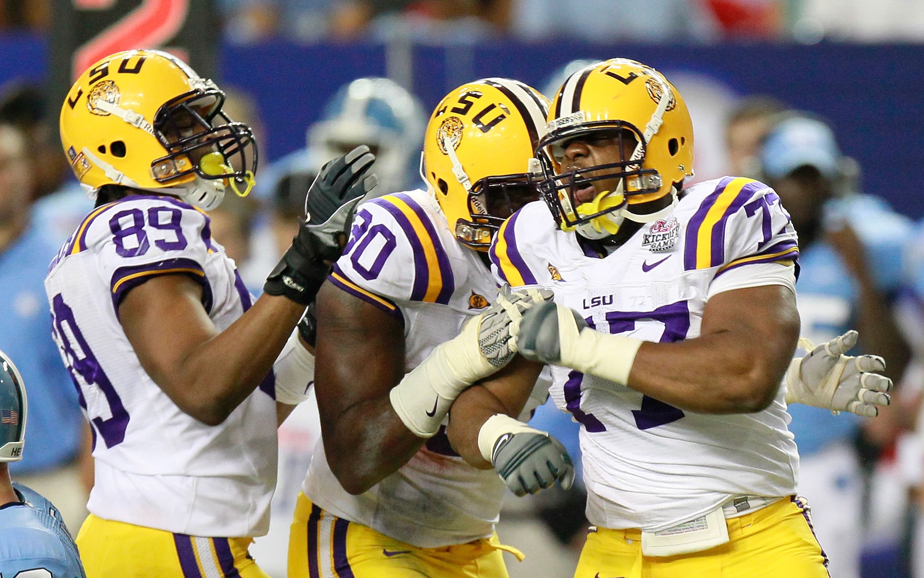 ATLANTA - SEPTEMBER 04:  Lavar Edwards #89, Michael Brockers #90 and Josh Downs #77 of the LSU Tigers against the North Carolina Tar Heels during the Chick-fil-A Kickoff Game at Georgia Dome on September 4, 2010 in Atlanta, Georgia.  (Photo by Kevin C. Co
