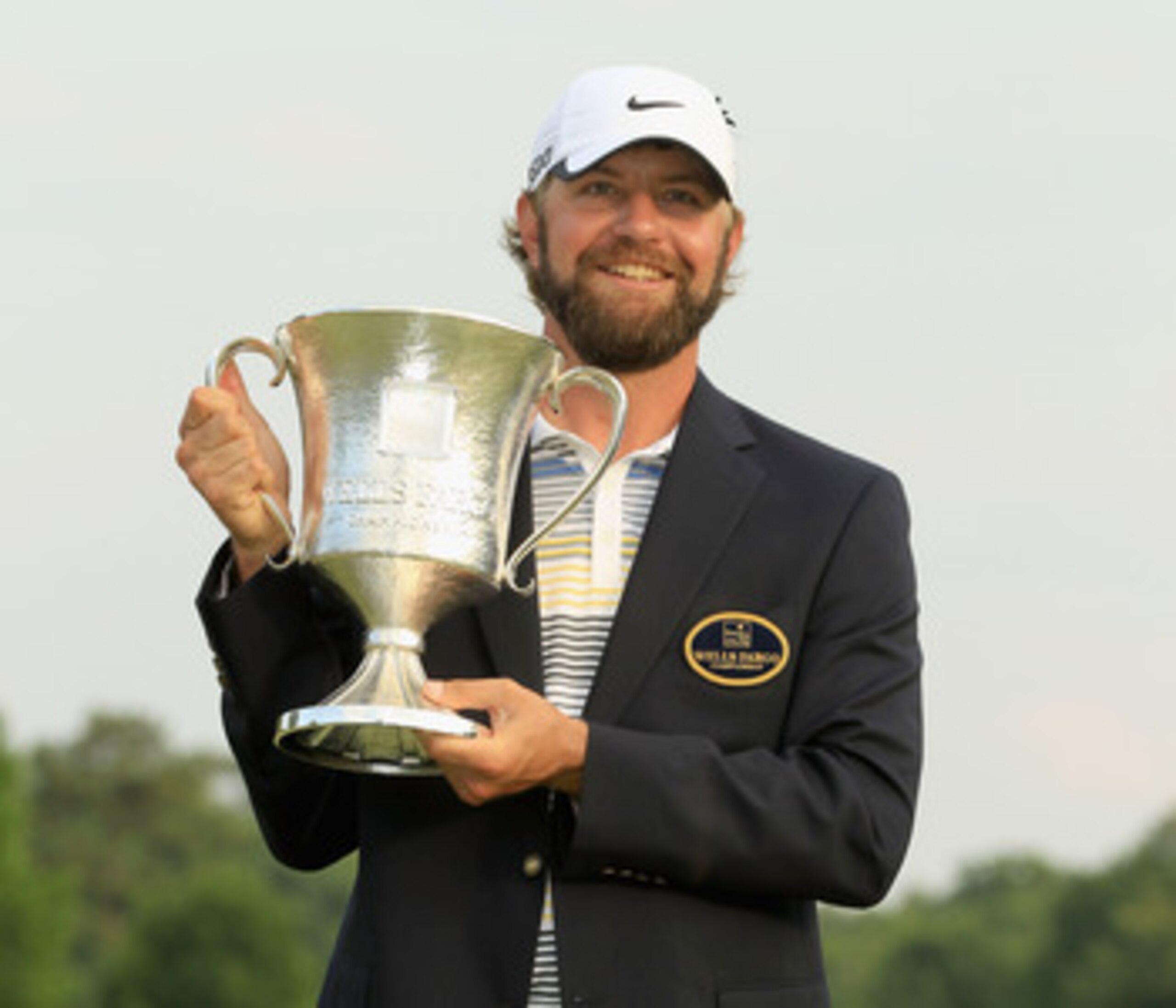 CHARLOTTE, NC - MAY 08:  Lucas Glover poses with the trophy after defeating Jonathan Byrd on the first playoff hole during the final round of the Wells Fargo Championship at the Quail Hollow Club on May 8, 2011 in Charlotte, North Carolina.  (Photo by Str