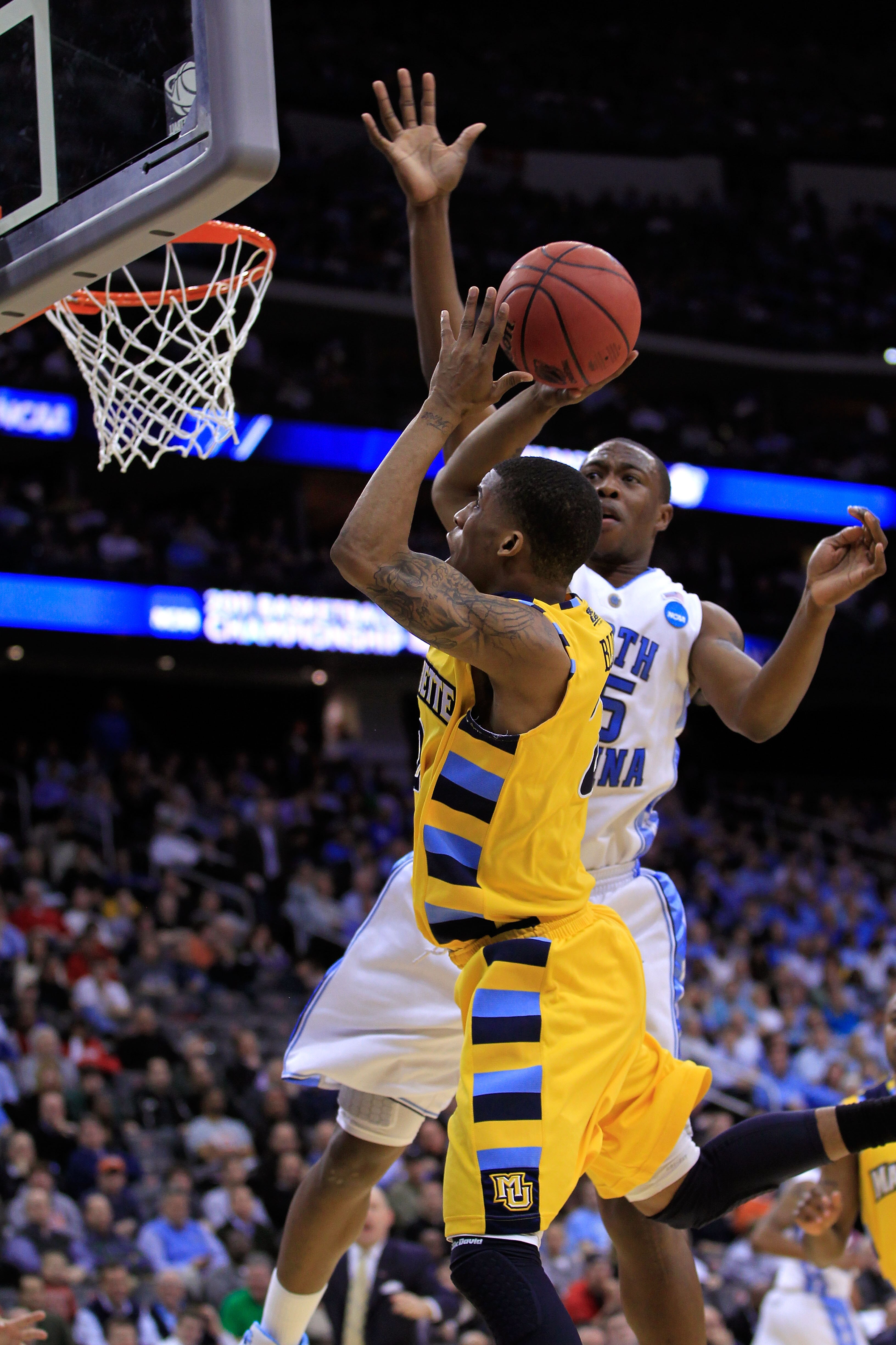 NEWARK, NJ - MARCH 25:  Vander Blue #2 of the Marquette Golden Eagles in action against Justin Knox #25 of the North Carolina Tar Heels during the east regional semifinal of the 2011 NCAA Men's Basketball Tournament at the Prudential Center on March 25, 2