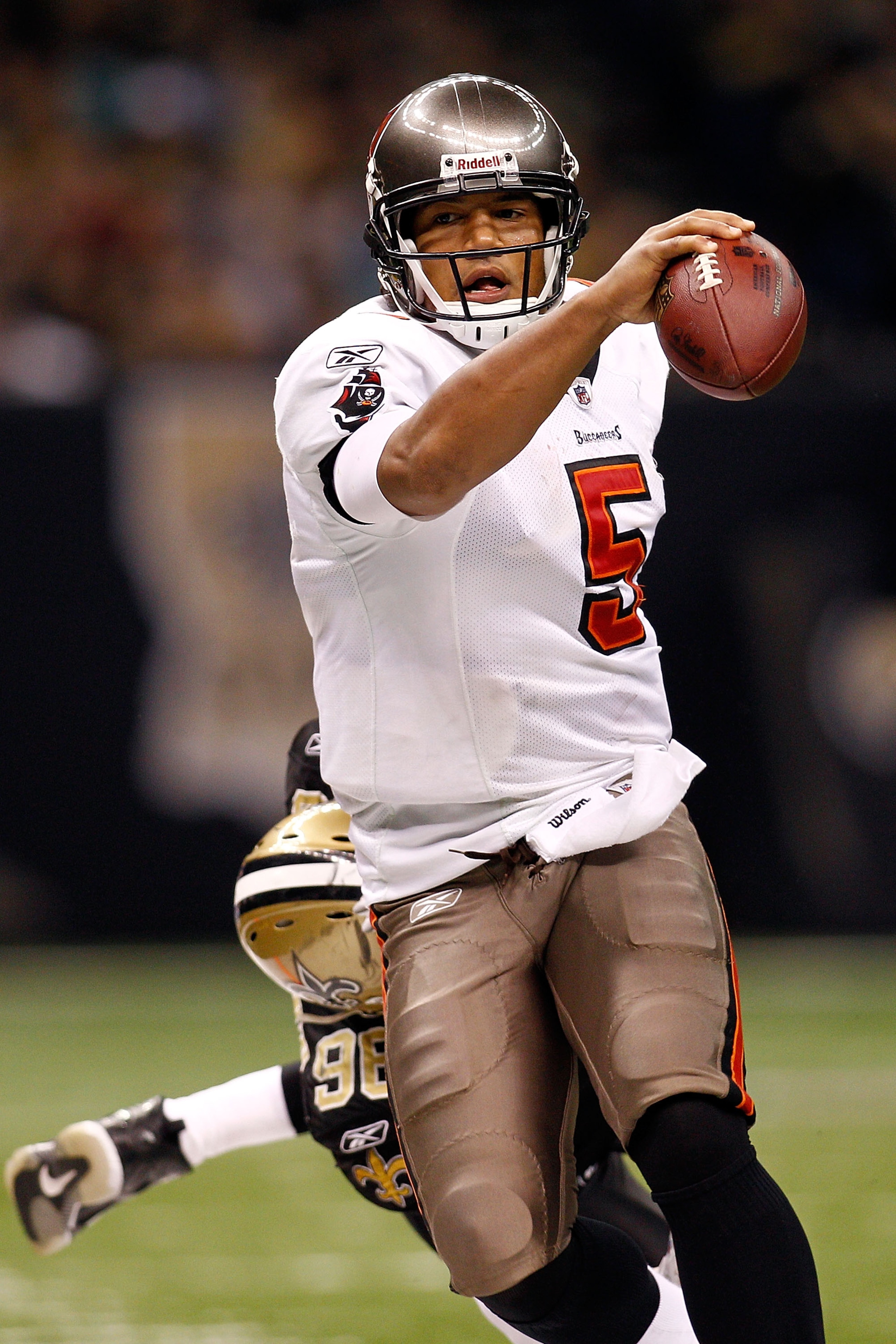 NEW ORLEANS, LA - JANUARY 02: Quarterback Josh Freeman #5 of the Tampa Bay Buccaneers is pushed out of bounds by Alex Brown #96 of the New Orleans Saints at the Louisiana Superdome on January 2, 2011 in New Orleans, Louisiana. The Buccaneers defeated th NEW ORLEANS, LA - JANUARY 02: Quarterback Josh Freeman #5 of the Tampa Bay Buccaneers is pushed out of bounds by Alex Brown #96 of the New Orleans Saints at the Louisiana Superdome on January 2, 2011 in New Orleans, Louisiana. The Buccaneers defeated th