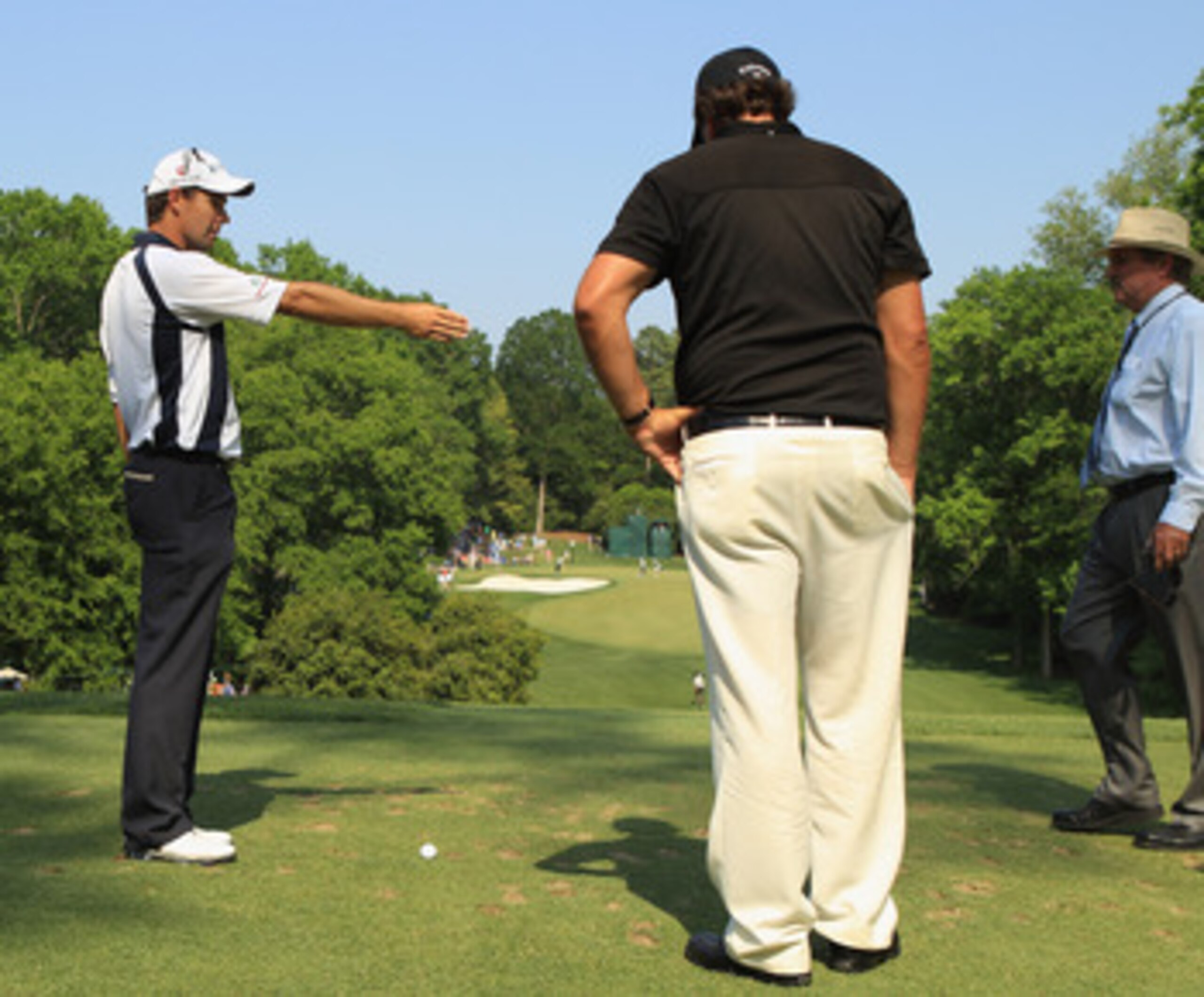 CHARLOTTE, NC - MAY 08:  Phil Mickelson (C) and Padraig Harrington of Ireland (L) look over the 13th tee box with PGA Tour rules official Slugger White (R) walk off the fourth tee during the final round of the Wells Fargo Championship at the Quail Hollow