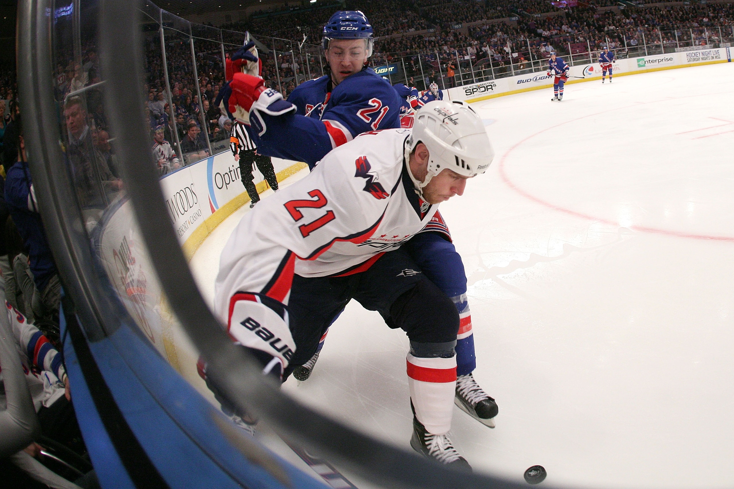 NEW YORK, NY - APRIL 20:  Brooks Laich #21 of the Washington Capitals attempt to control the puck along the boards against Derek Stepan #21 of the New York Rangers in Game Four of the Eastern Conference Quarterfinals during the 2011 NHL Stanley Cup Playof