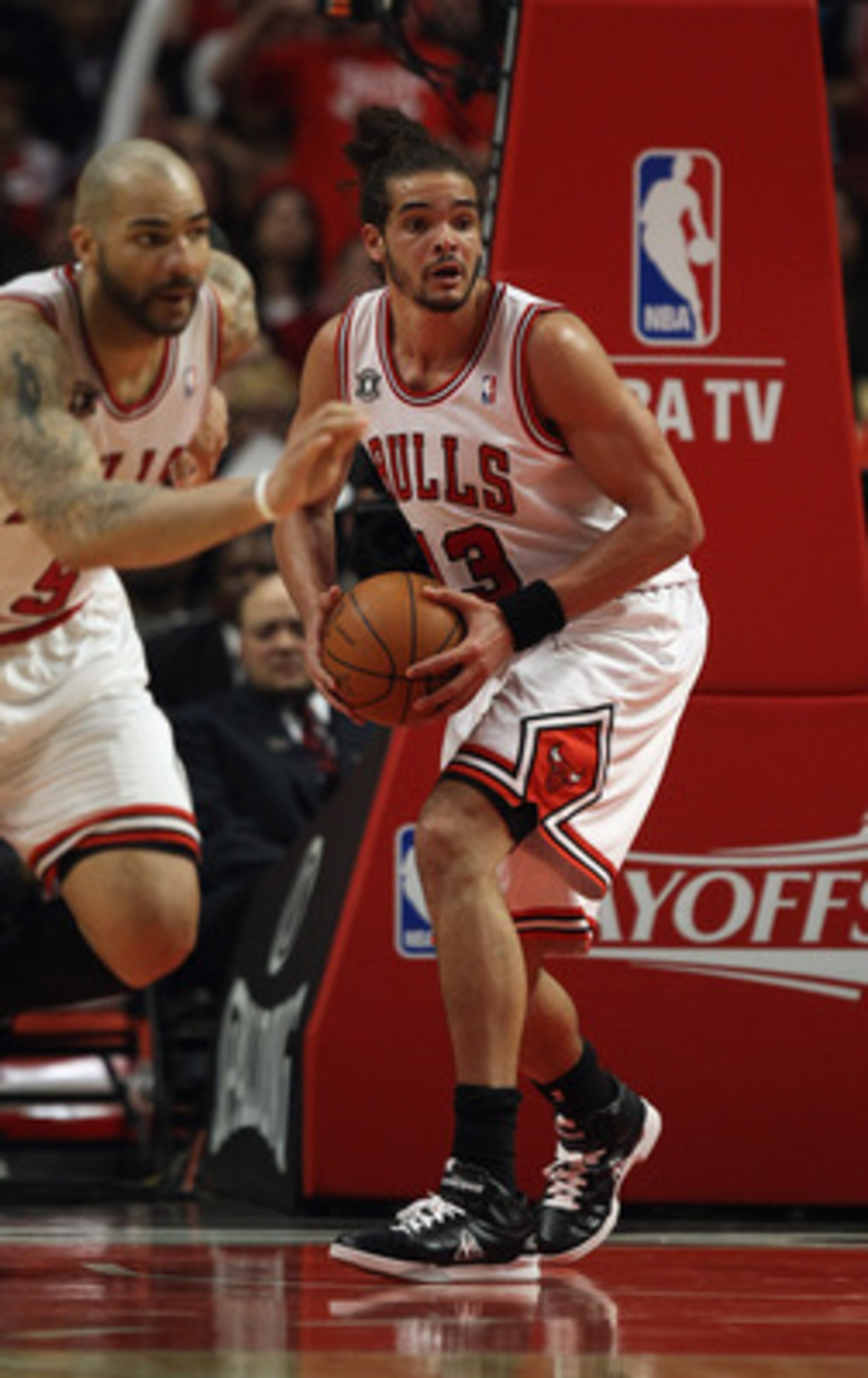 CHICAGO, IL - MAY 04: Joakim Noah #13 of the Chicago Bulls looks to pass after grabbing a rebound as teammate Carlos Boozers #5 heads up the court against the Atlanta Hawks in Game Two of the Eastern Conference Semifinals in the 2011 NBA Playoffs at the U