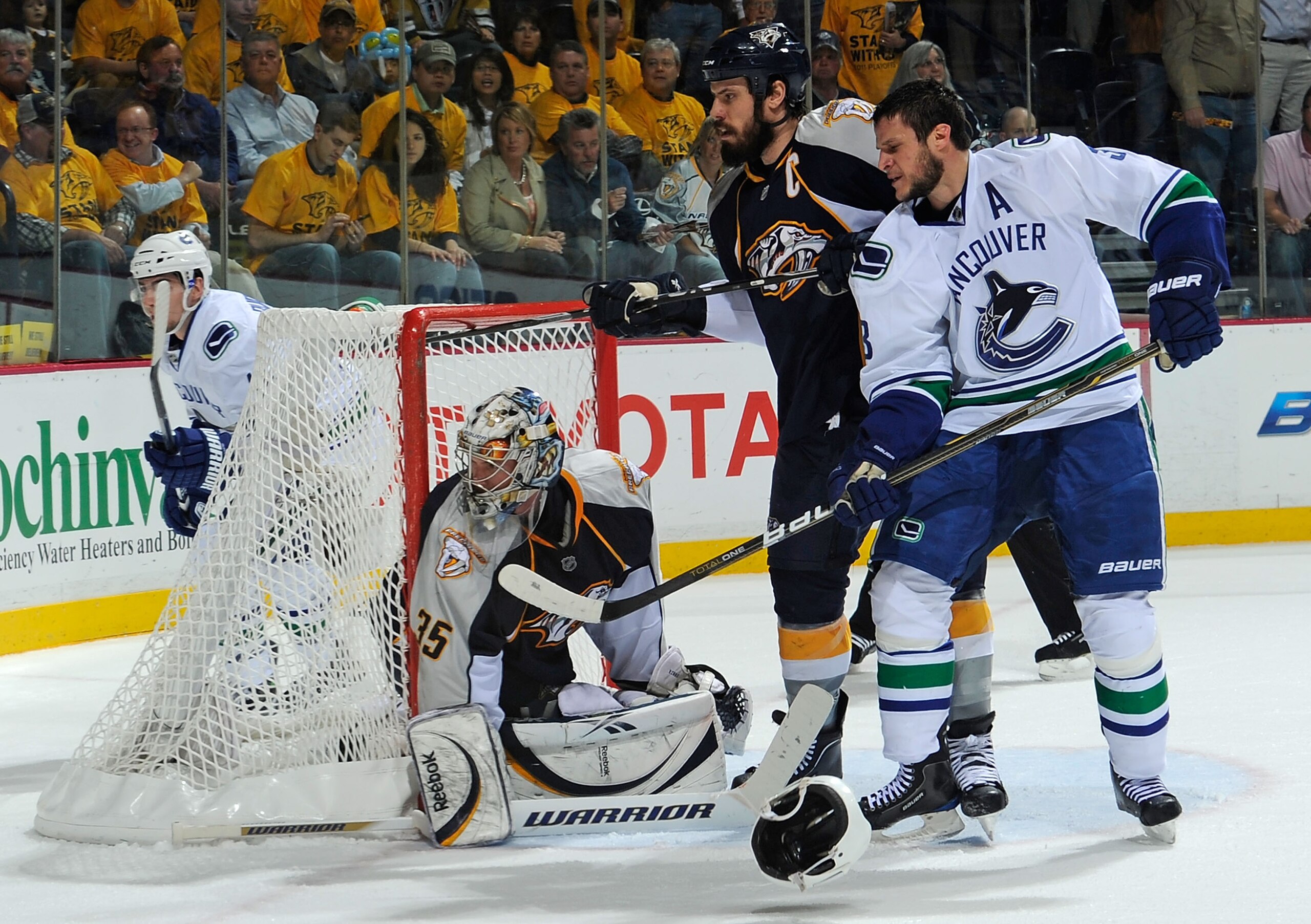NASHVILLE, TN - MAY 05:  Kevin Bieksa #3 of the Vancouver Canucks fights for position in front of Shea Weber #6 and goalie Pekka Rinne #35 of the Nashville Predators in Game Four of the Western Conference Semifinals at Bridgestone Arena on May 5, 2011 in