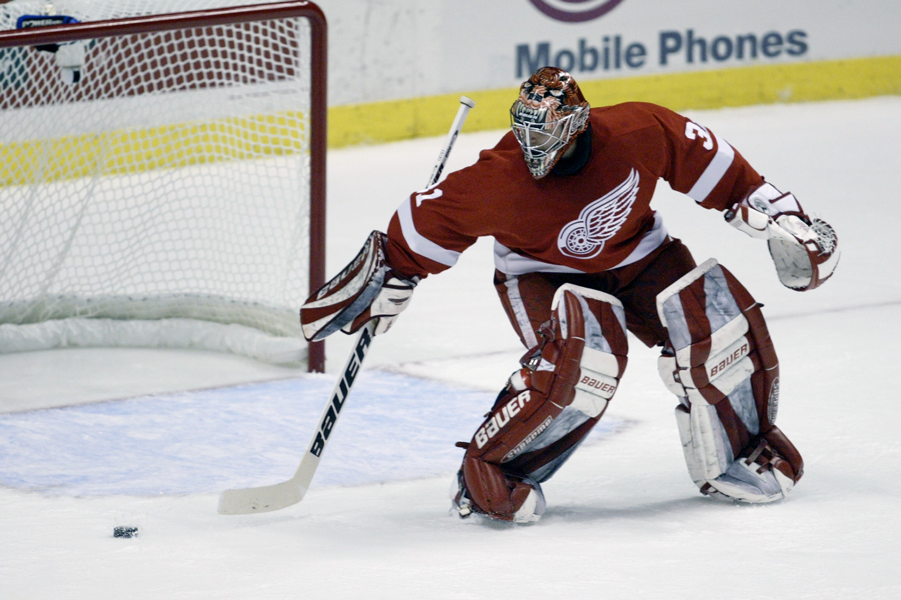 ANAHEIM, CA - APRIL 16:  Curtis Joseph #31 of the Detroit Red Wings plays the puck against the Mighty Ducks of Anaheim during round one of the 2003 Stanley Cup playoffs at the Arrowhead Pond of Anaheim on April 16, 2003 in Anaheim, California. (Photo by D