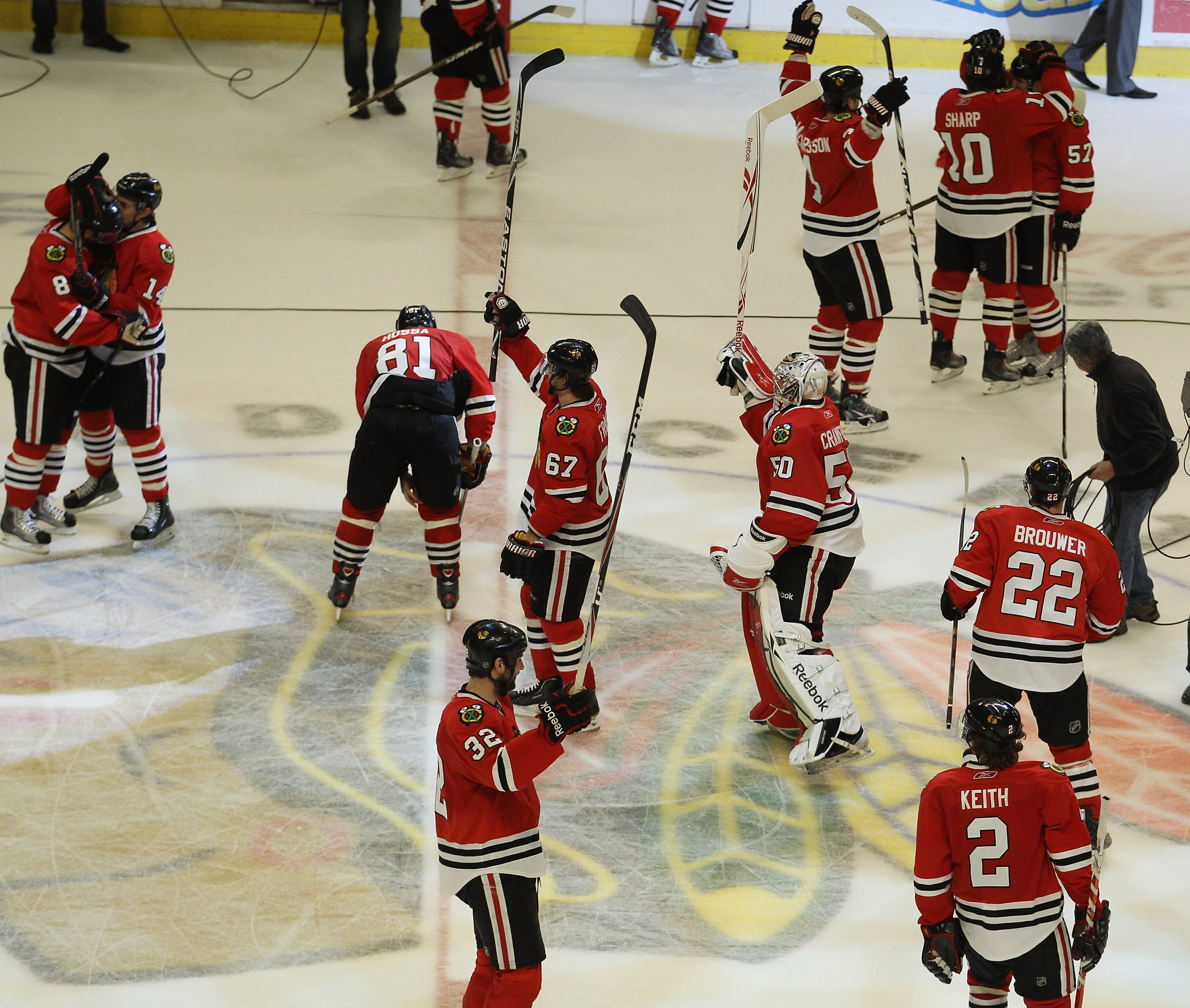 CHICAGO, IL - APRIL 24: Members of the Chicago Blackhawks salute the crowd and celebrate a win over the Vancouver Canucks in Game Six of the Western Conference Quarterfinals during the 2011 NHL Stanley Cup Playoffs at the United Center on April 24, 2011 i