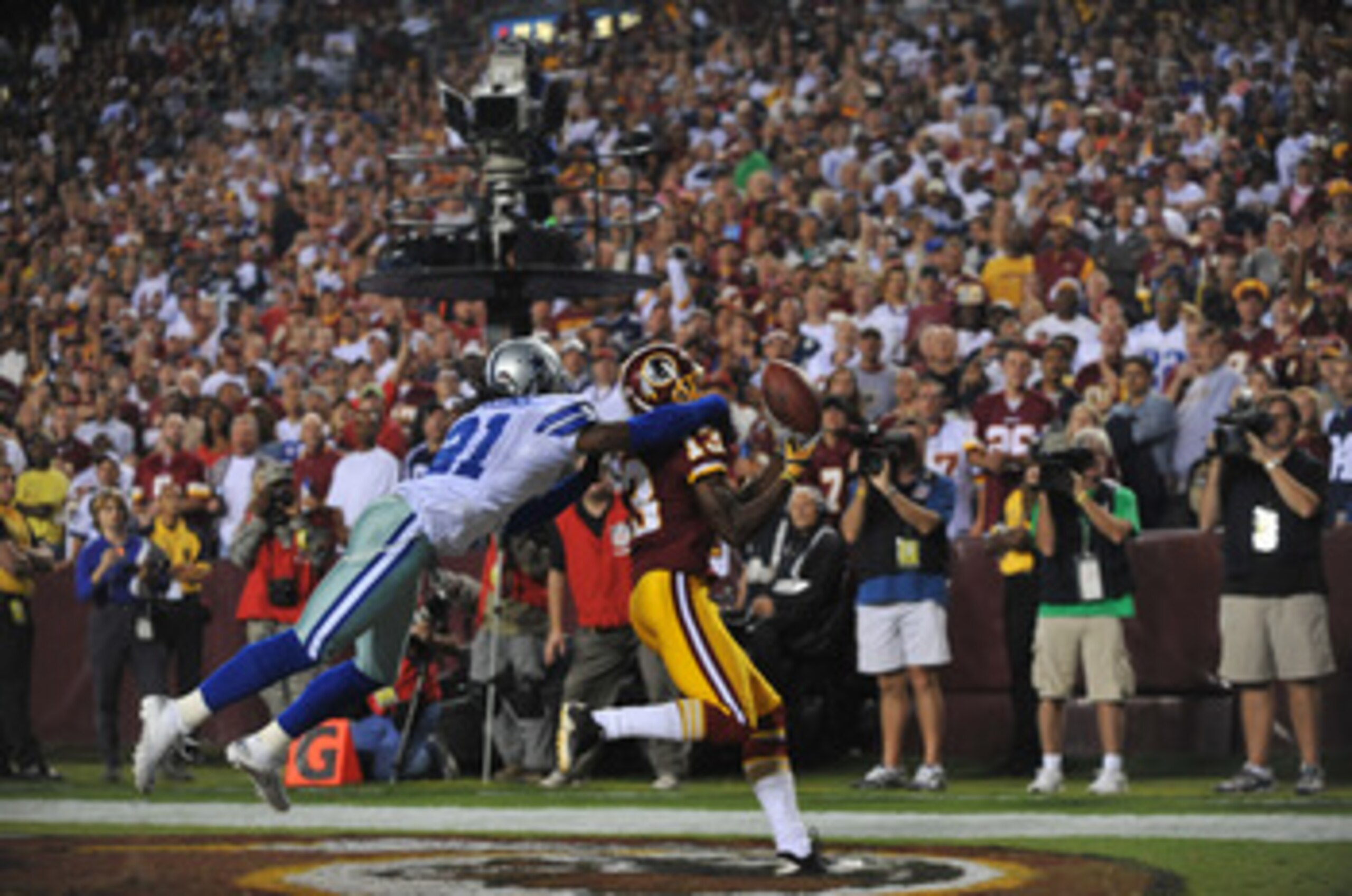 LANDOVER - SEPTEMBER 12:  Mike Jenkins #21 of the Dallas Cowboys knocks the ball loose from Anthony Armstrong #13 of the Washington Redskins during the NFL season opener at FedExField on September 12, 2010 in Landover, Maryland. The Redskins defeated the 