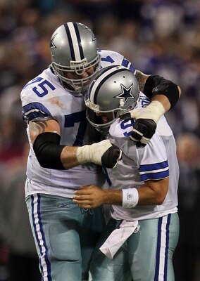 MINNEAPOLIS - OCTOBER 17:  Marc Colombo #75 and Tony Romo #9 of the Dallas Cowboys celebrate during the game against the Minnesota Vikings at Mall of America Field on October 17, 2010 in Minneapolis, Minnesota.  (Photo by Jeff Gross/Getty Images)