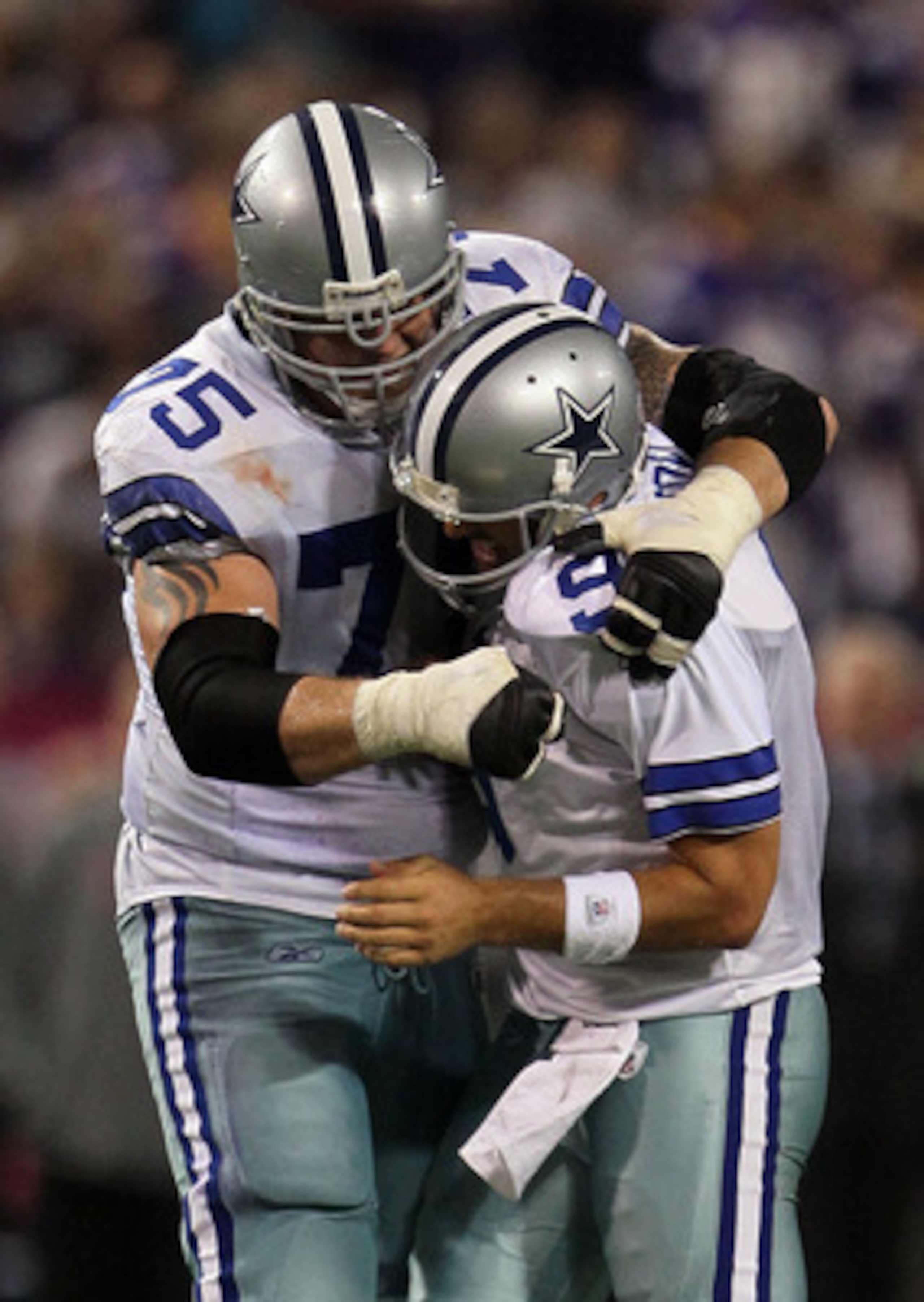 MINNEAPOLIS - OCTOBER 17:  Marc Colombo #75 and Tony Romo #9 of the Dallas Cowboys celebrate during the game against the Minnesota Vikings at Mall of America Field on October 17, 2010 in Minneapolis, Minnesota.  (Photo by Jeff Gross/Getty Images)