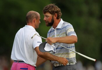 CHARLOTTE, NC - MAY 08:  Lucas Glover (R) shakes hands with Jonathan Byrd on the 18th green after defeating Byrd on the first playoff hole during the final round of the Wells Fargo Championship at the Quail Hollow Club on May 8, 2011 in Charlotte, North C