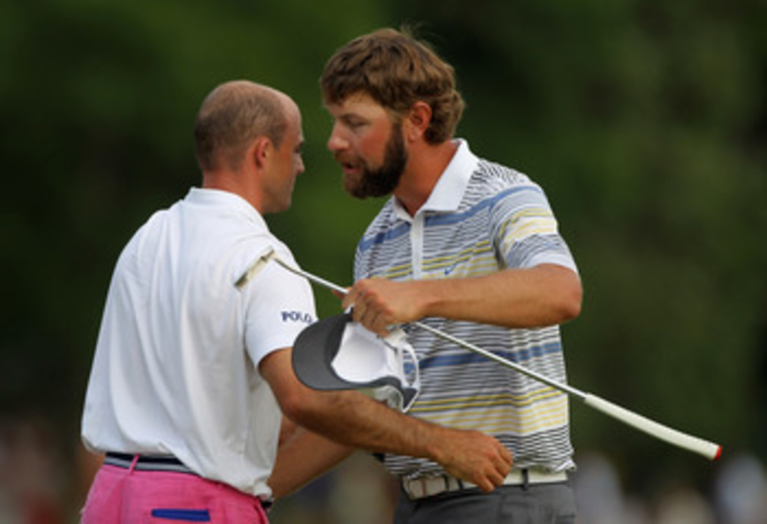 CHARLOTTE, NC - MAY 08:  Lucas Glover (R) shakes hands with Jonathan Byrd on the 18th green after defeating Byrd on the first playoff hole during the final round of the Wells Fargo Championship at the Quail Hollow Club on May 8, 2011 in Charlotte, North C
