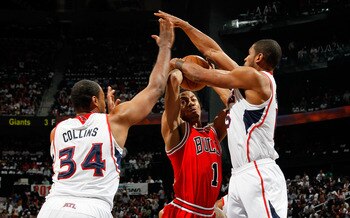 ATLANTA, GA - MAY 08:  Jason Collins #34 and Al Horford #15 of the Atlanta Hawks defend against a a driving Derrick Rose #1 of the Chicago Bulls in Game Four of the Eastern Conference Semifinals in the 2011 NBA Playoffs at Phillips Arena on May 8, 2011 in