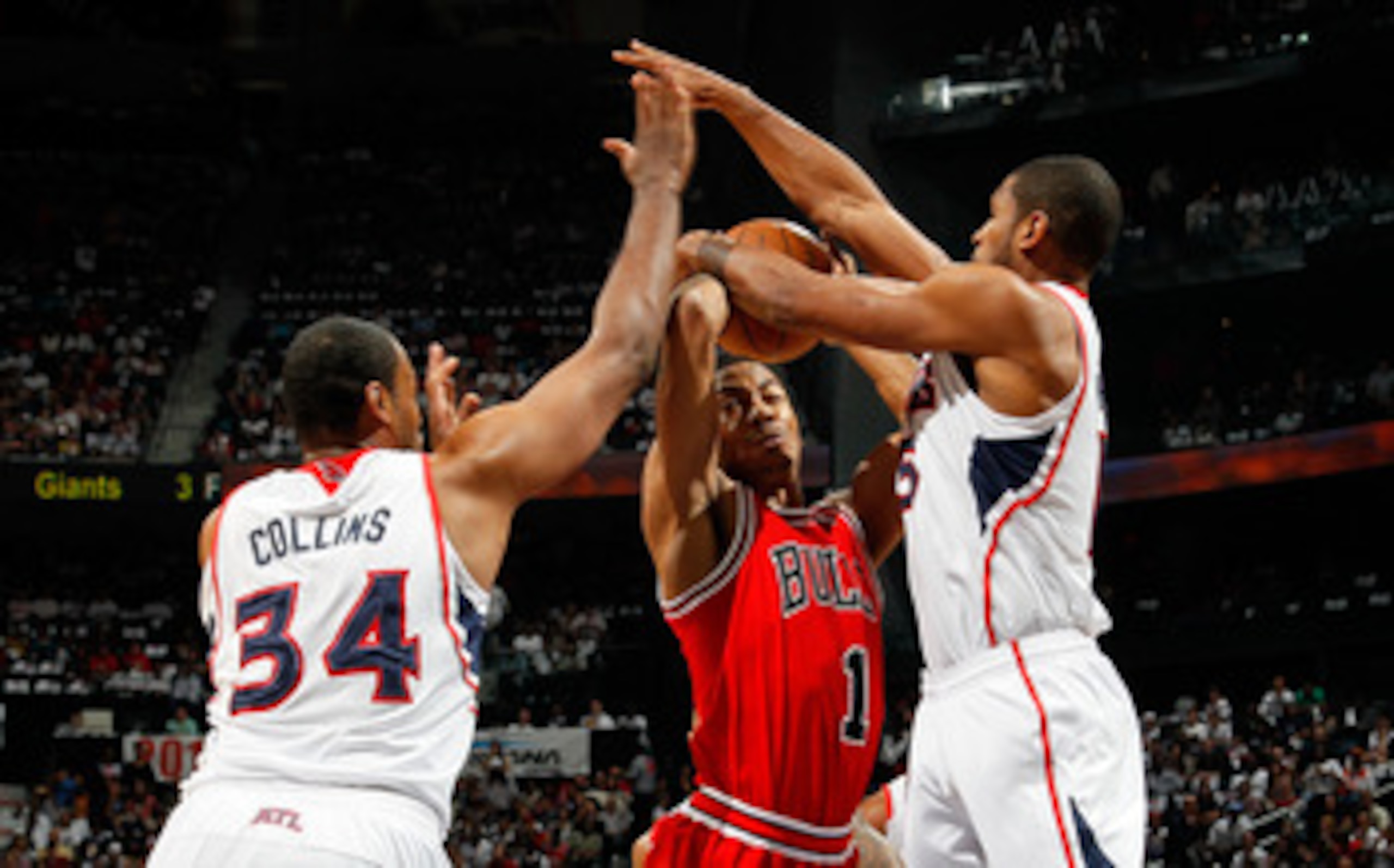 ATLANTA, GA - MAY 08:  Jason Collins #34 and Al Horford #15 of the Atlanta Hawks defend against a a driving Derrick Rose #1 of the Chicago Bulls in Game Four of the Eastern Conference Semifinals in the 2011 NBA Playoffs at Phillips Arena on May 8, 2011 in