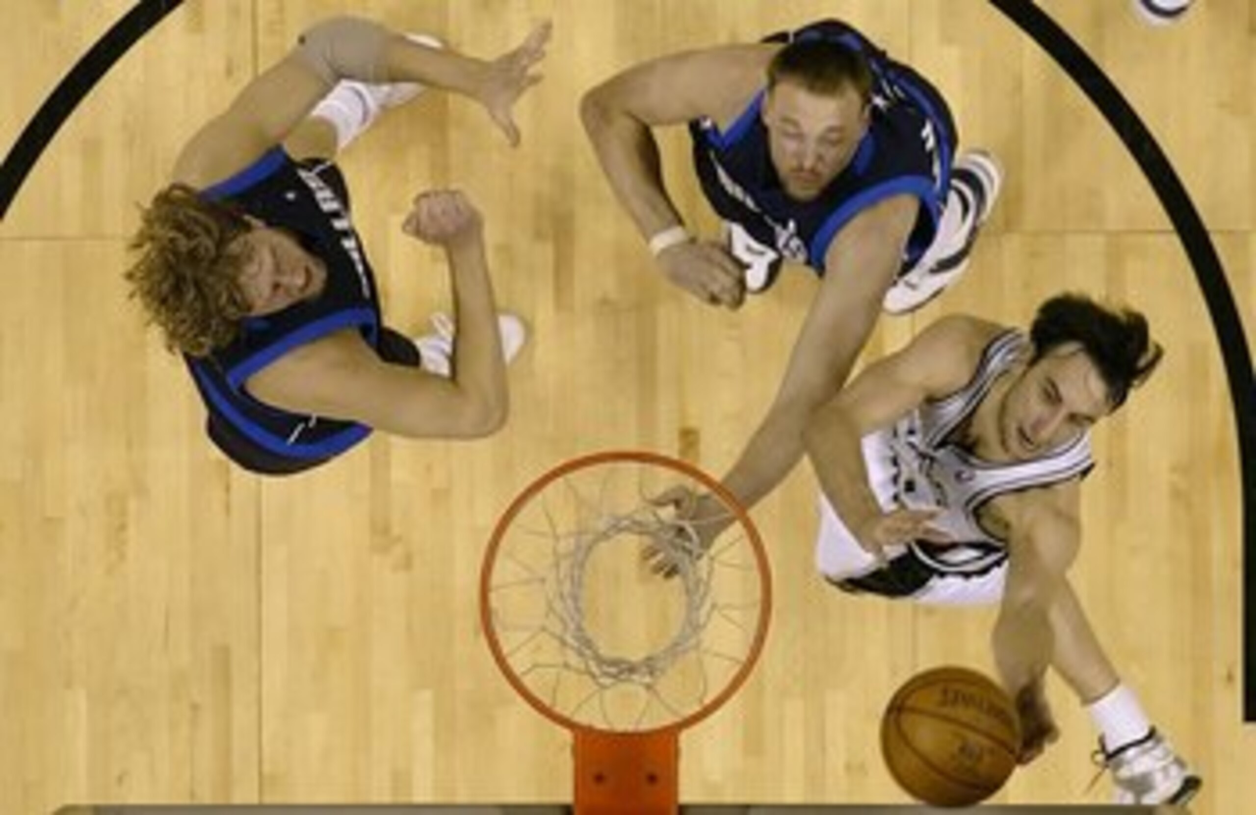 SAN ANTONIO - MAY 22:  Manu Ginobili #20 of the San Antonio Spurs drives for a shot attempt against Keith Van Horn #2 and Dirk Nowitzki #41 of the Dallas Mavericks in Game Seven of the Western Conference Semifinals during the 2006 NBA Playoffs May 22, 200