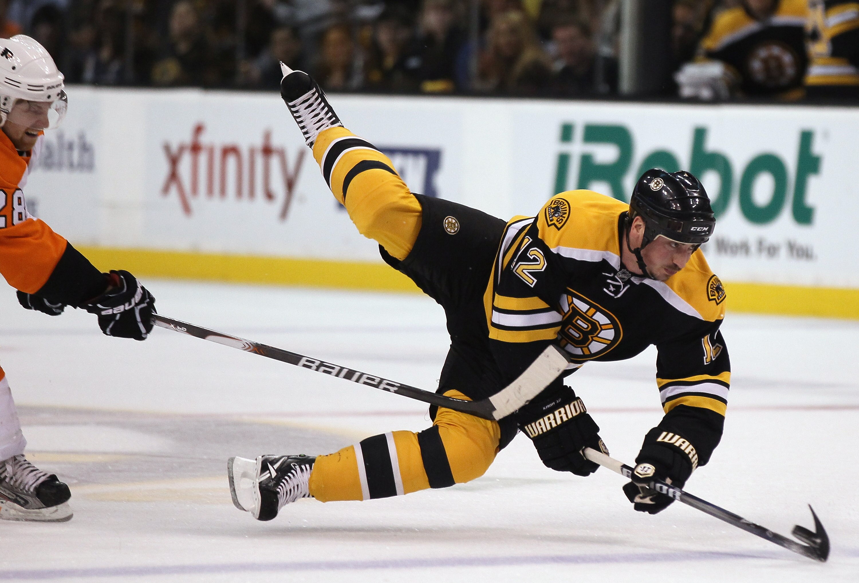 BOSTON, MA - MAY 06:  Tomas Kaberle #12 of the Boston Bruins is tripped by Claude Giroux #28 of the Philadelphia Flyers in Game Four of the Eastern Conference Semifinals during the 2011 NHL Stanley Cup Playoffs at TD Garden on May 6, 2011 in Boston, Massa