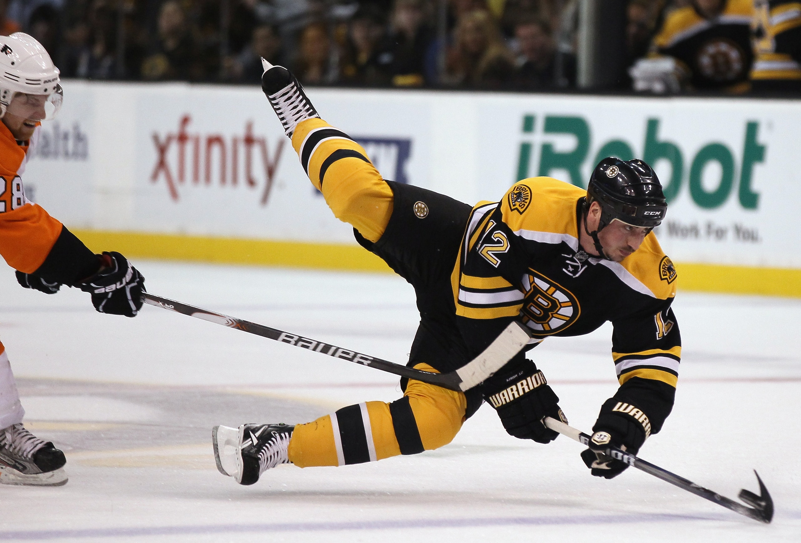 BOSTON, MA - MAY 06:  Tomas Kaberle #12 of the Boston Bruins is tripped by Claude Giroux #28 of the Philadelphia Flyers in Game Four of the Eastern Conference Semifinals during the 2011 NHL Stanley Cup Playoffs at TD Garden on May 6, 2011 in Boston, Massa