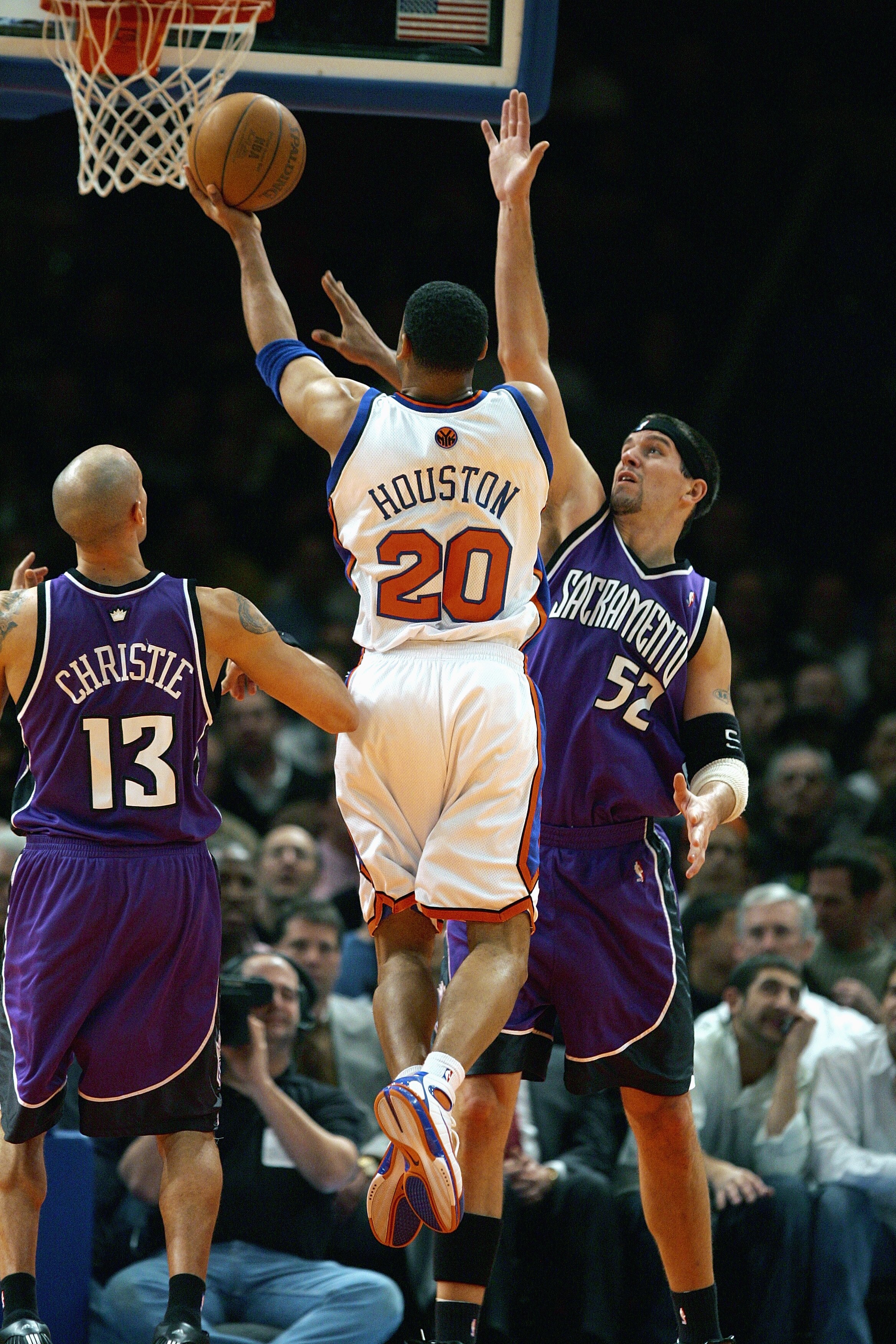 NEW YORK - JANUARY 4:  Allan Houston #20 of the New York Knicks drives to the basket against Brad Miller #52 of the Sacramento Kings on January 4, 2005 at Madison Square Garden in New York City. The Kings won 105-98.  NOTE TO USER: User expressly acknowle