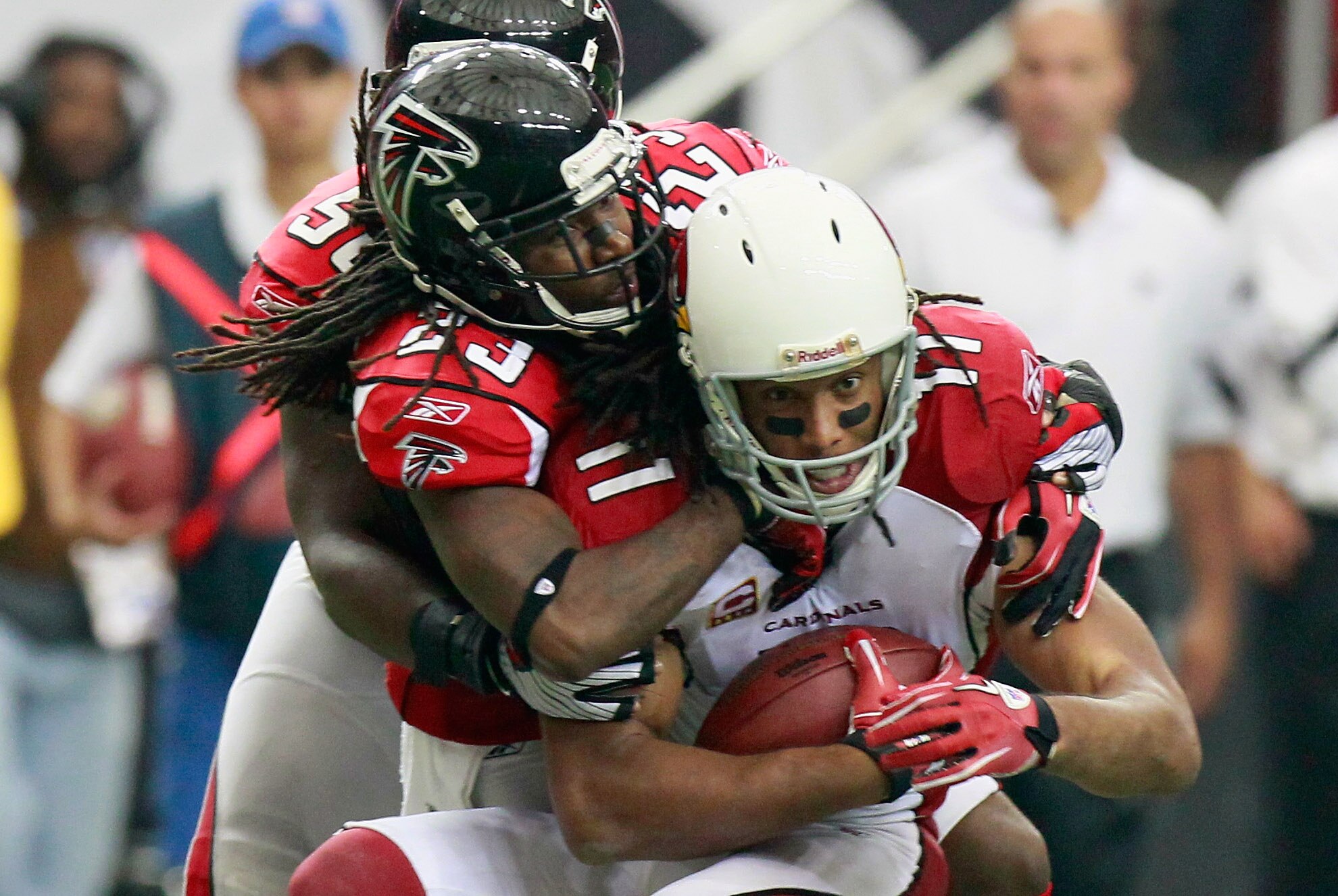 ATLANTA - SEPTEMBER 19:  Dunta Robinson #23 of the Atlanta Falcons tackles Larry Fitzgerald #11 of the Arizona Cardinals at Georgia Dome on September 19, 2010 in Atlanta, Georgia.  (Photo by Kevin C. Cox/Getty Images)