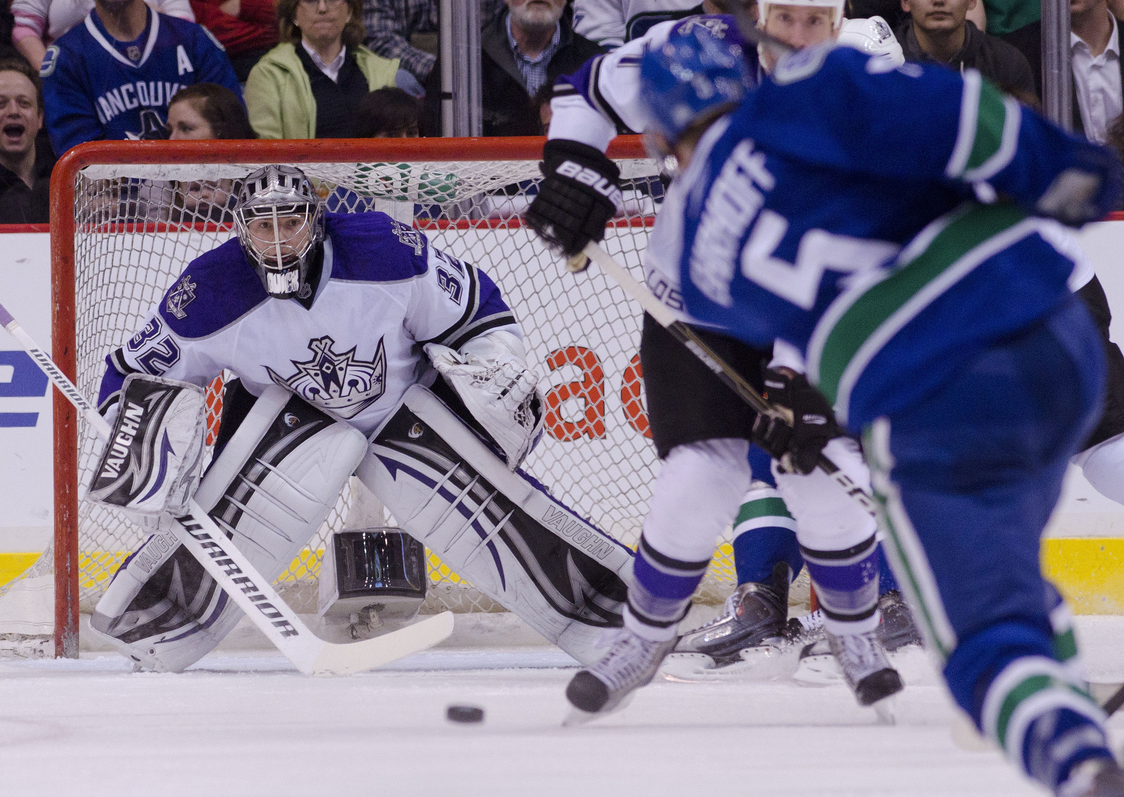 VANCOUVER, CANADA - MARCH 31: Goalie Jonathan Quick #32 of the Los Angeles Kings keeps an eye on the puck after being shot by Christian Ehrhoff #5 of the Vancouver Canucks during the first period in NHL action on March 31, 2011 at Rogers Arena in Vancouve