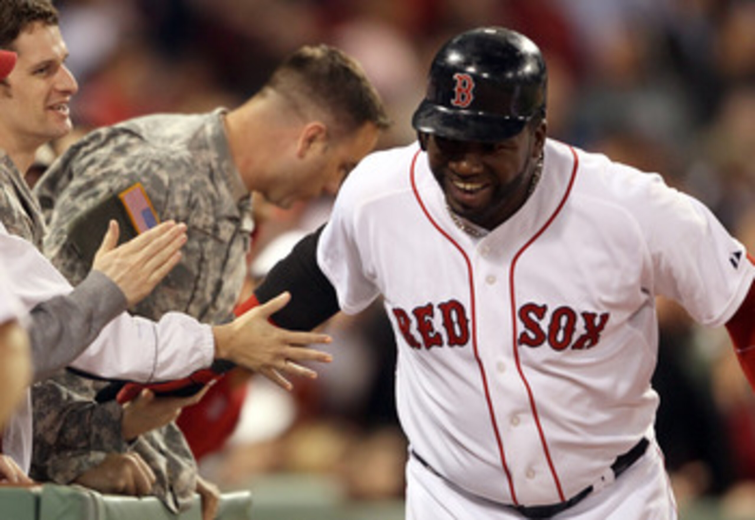 BOSTON, MA - MAY 02: David Ortiz #34 of the Boston Red Sox celebrates his two run homer with military members sitting in the front row in the seventh inning against the Los Angeles Angels on May 2, 2011 at Fenway Park in Boston, Massachusetts. (Photo by BOSTON, MA - MAY 02: David Ortiz #34 of the Boston Red Sox celebrates his two run homer with military members sitting in the front row in the seventh inning against the Los Angeles Angels on May 2, 2011 at Fenway Park in Boston, Massachusetts. (Photo by