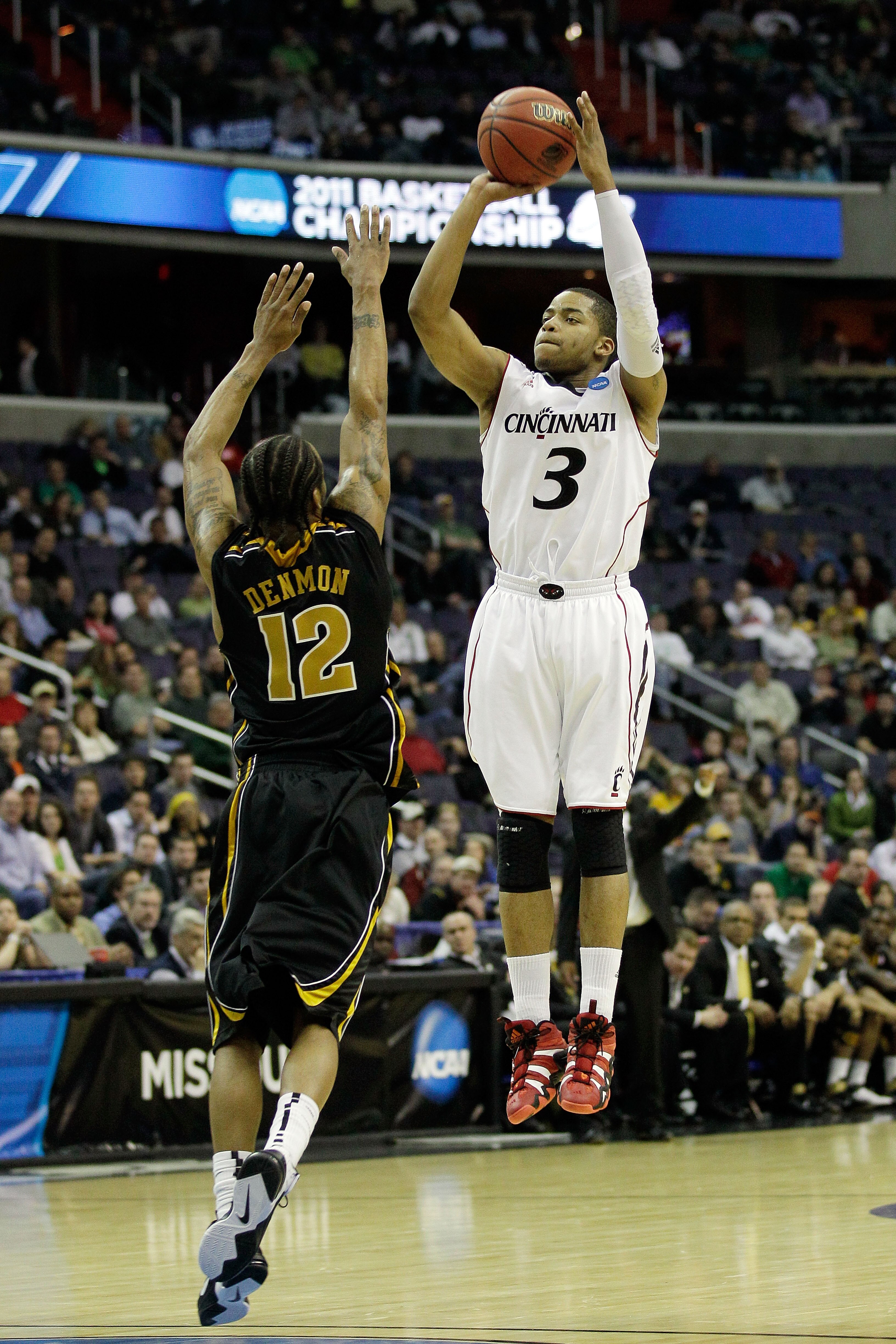 WASHINGTON - MARCH 17:  Dion Dixon #3 of the Cincinnati Bearcats shoots over Marcus Denmon #12 of the Missouri Tigers during the second round of the 2011 NCAA men's basketball tournament at the Verizon Center on March 17, 2011 in Washington, DC.  (Photo b
